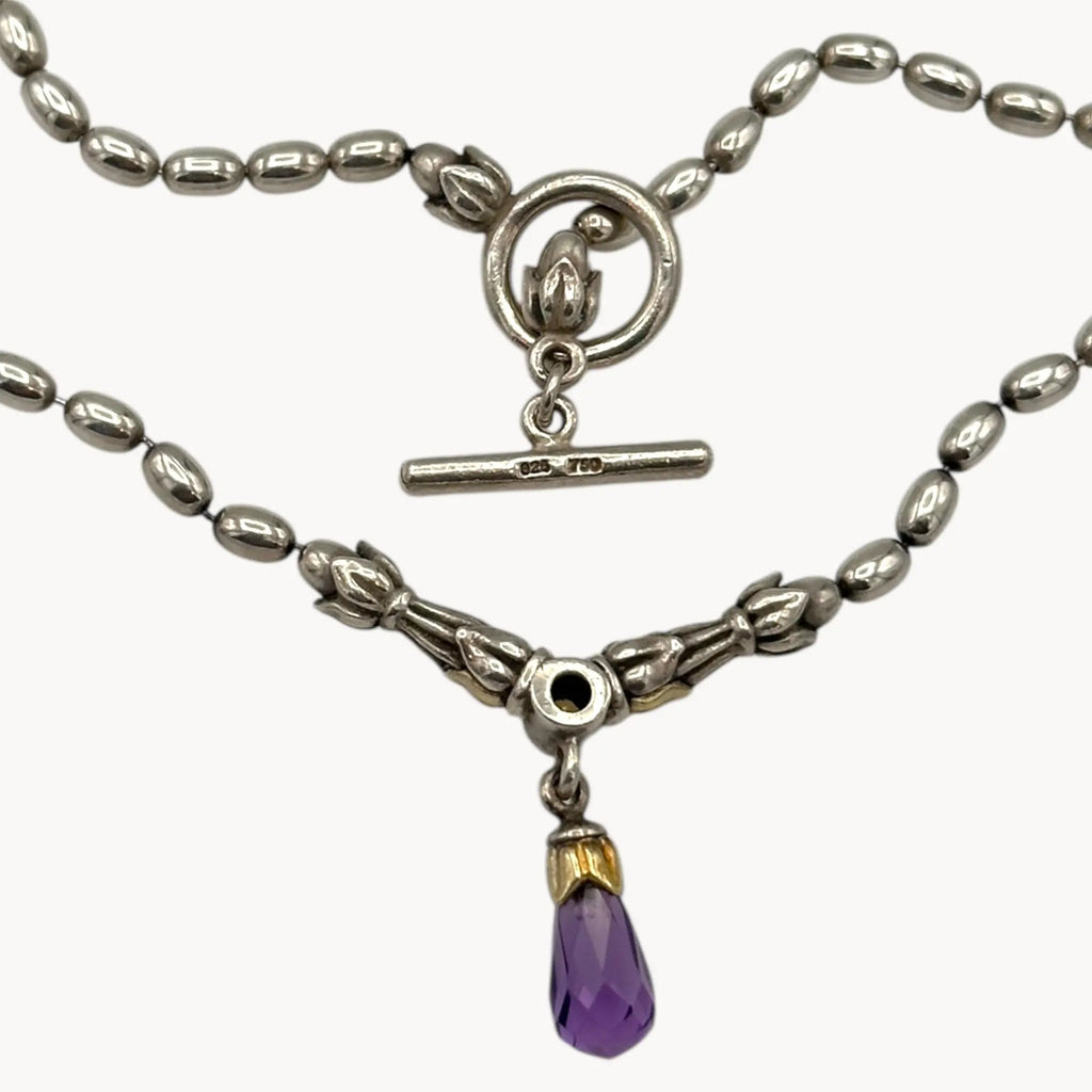 Back view of Sterling silver and 14K yellow gold necklace with amethyst teardrop pendant on white background.