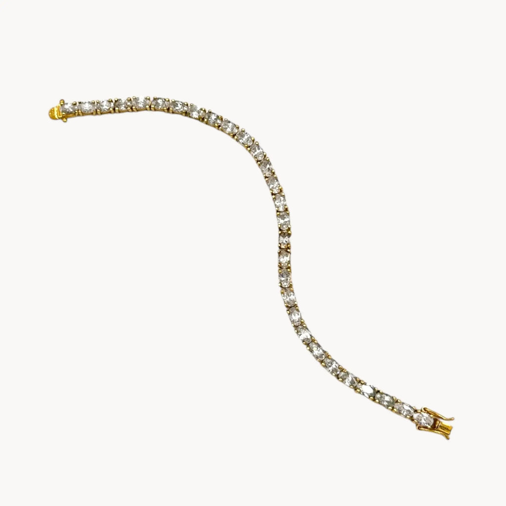 Against white background view of Sterling silver vermeil CZ tennis bracelet with brilliant round stones, vintage bridal and evening jewelry.