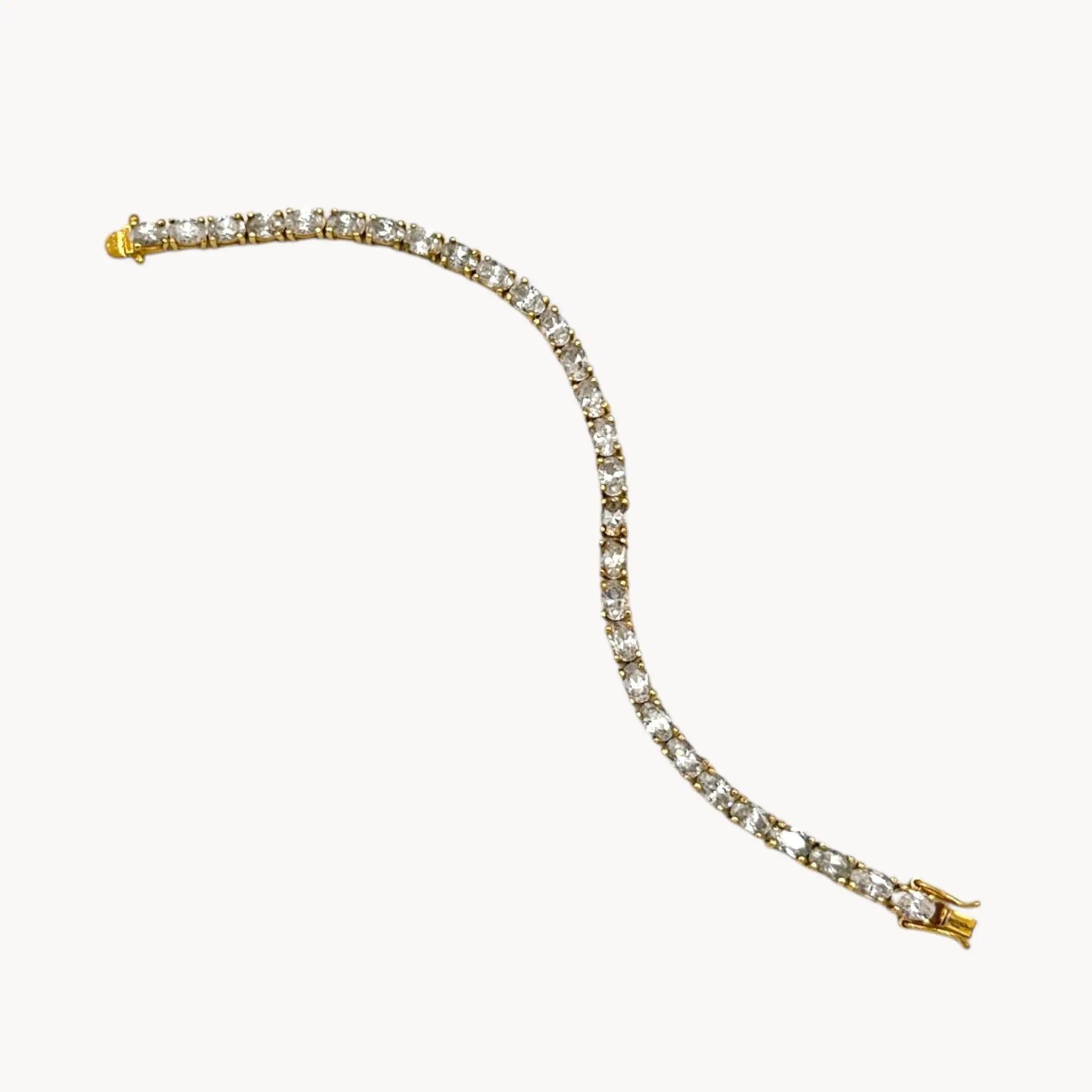 Against white background view of Sterling silver vermeil CZ tennis bracelet with brilliant round stones, vintage bridal and evening jewelry.