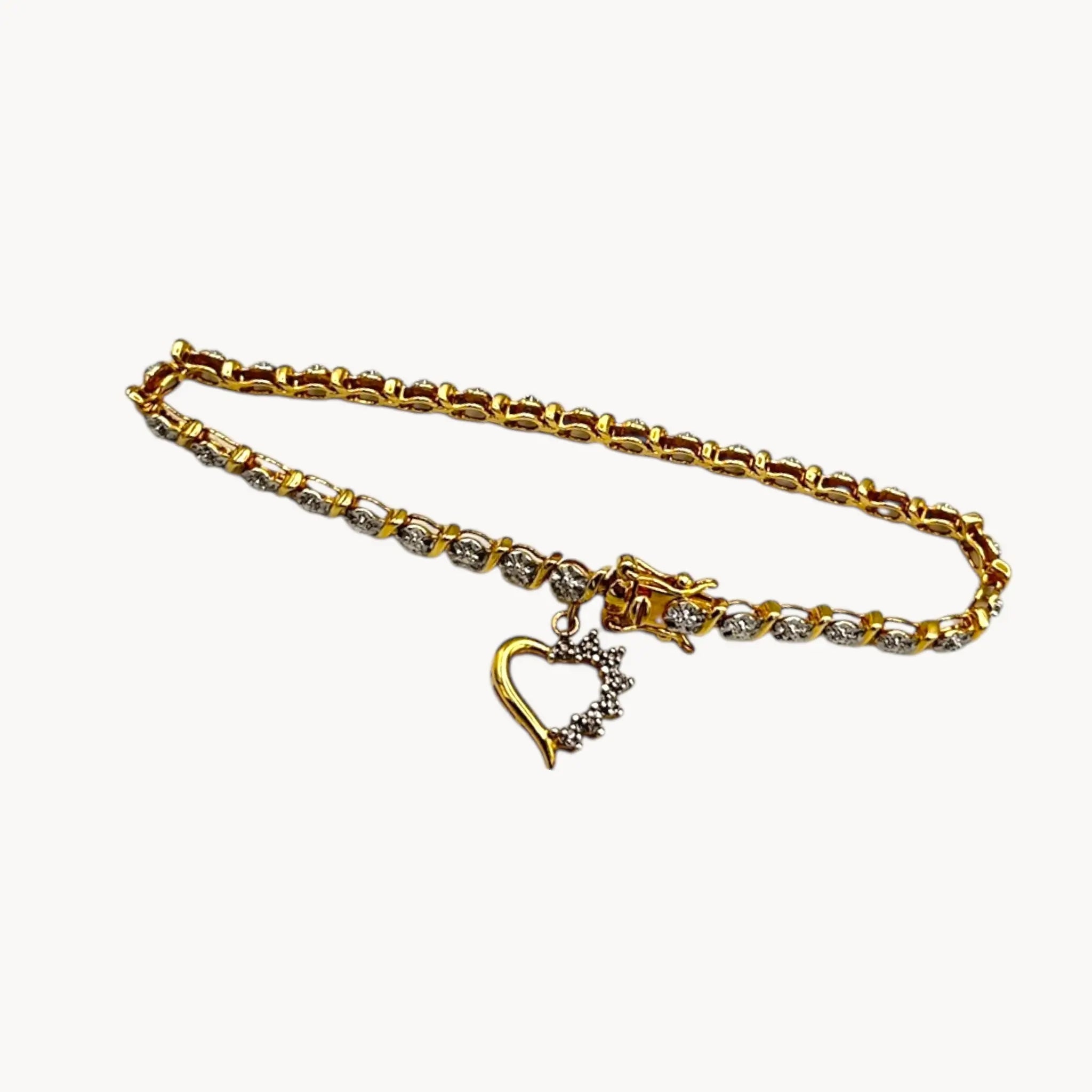 View on white background Shop vintage Sterling silver vermeil tennis bracelet with sparkling rhinestones and dangling heart charm, vintage romantic bridal jewelry.