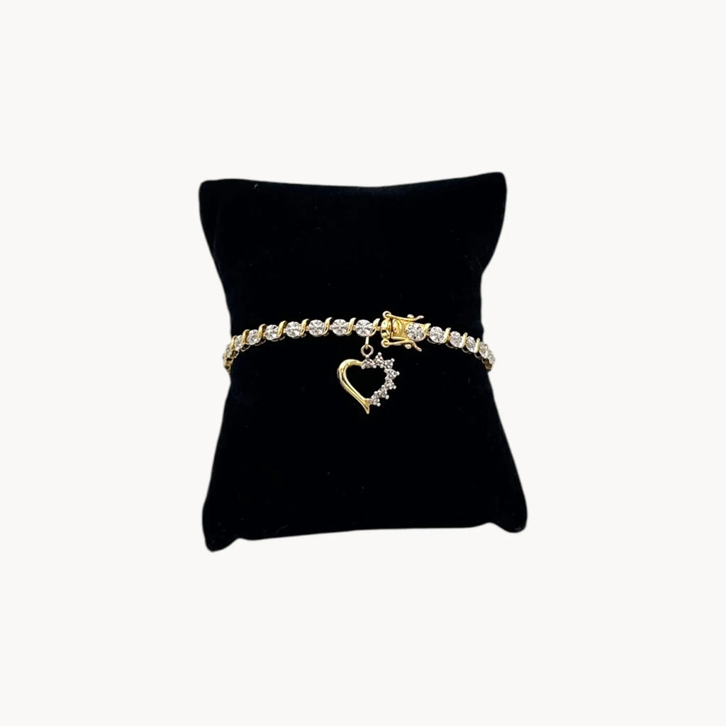 Shop vintage sterling silver vermeil tennis bracelet with rhinestones and heart charm. Romantic 1980s–1990s bridal jewelry or meaningful gift piece.