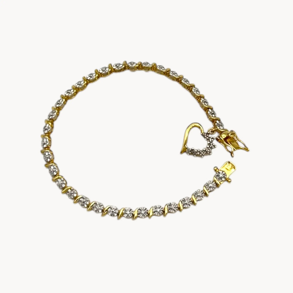 Close up view of Sterling silver vermeil tennis bracelet with sparkling rhinestones and dangling heart charm, vintage romantic bridal jewelry.