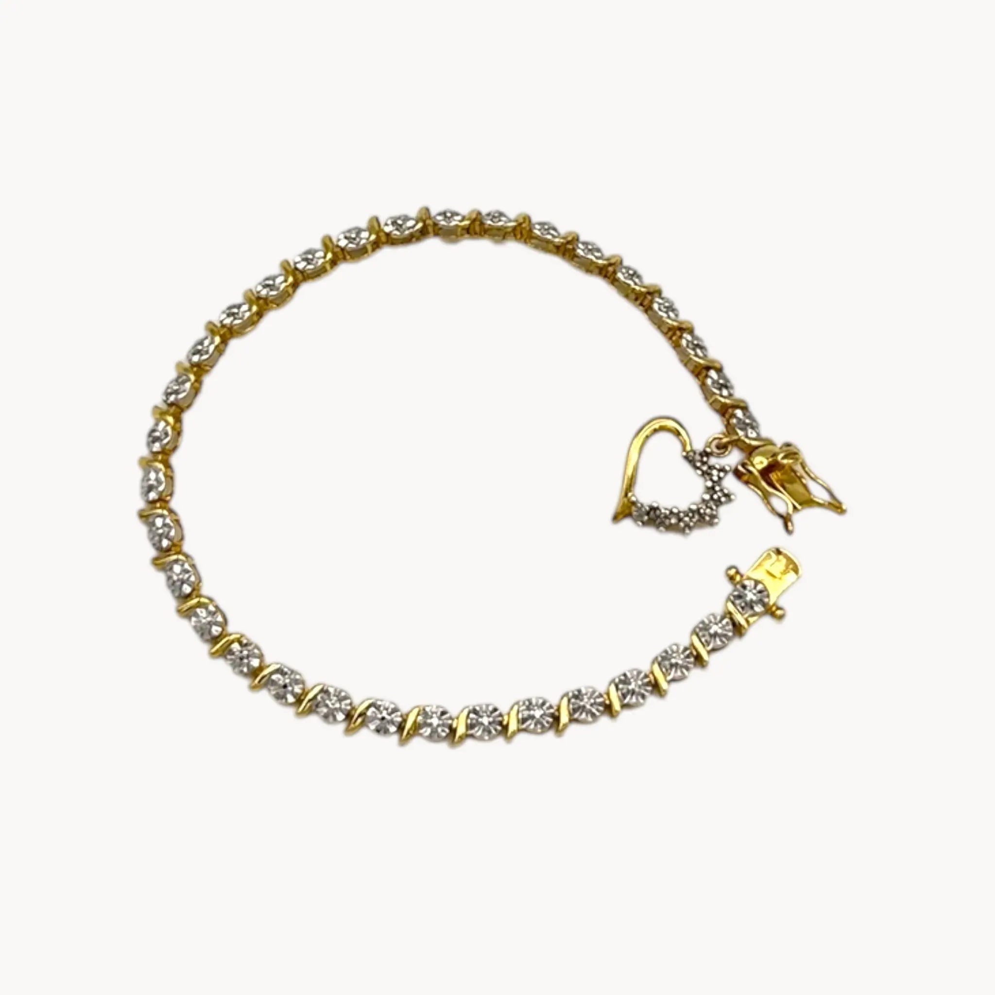 Close up view of Sterling silver vermeil tennis bracelet with sparkling rhinestones and dangling heart charm, vintage romantic bridal jewelry.