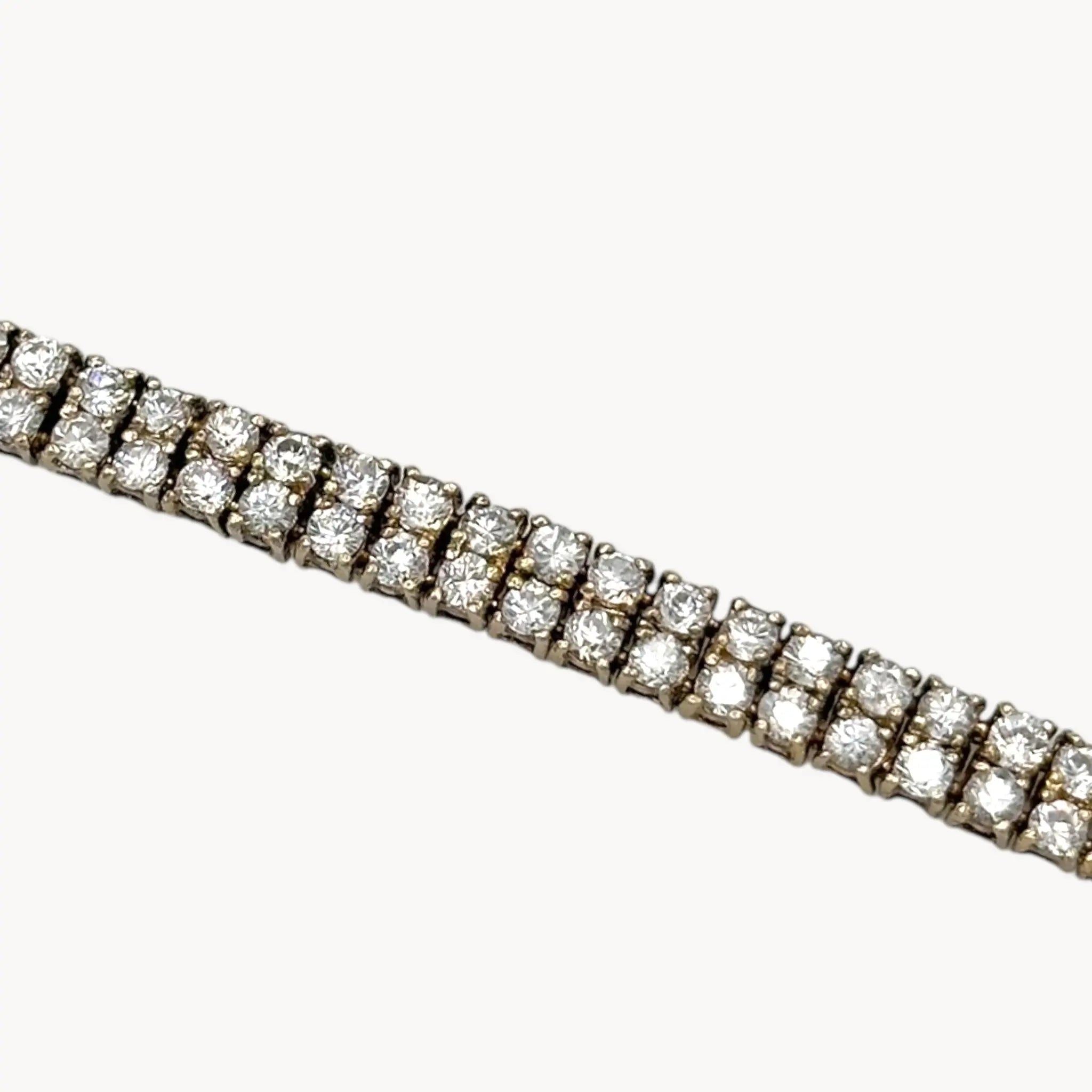 Close up view of Sterling silver vermeil gold plated two row CZ tennis bracelet.