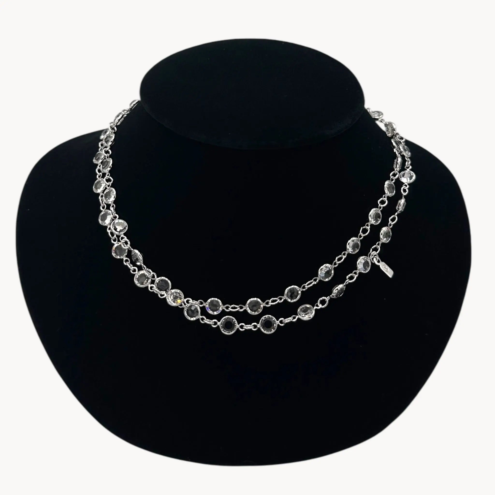 Close up view of Swarovski faceted clear crystal bezel set long necklace.