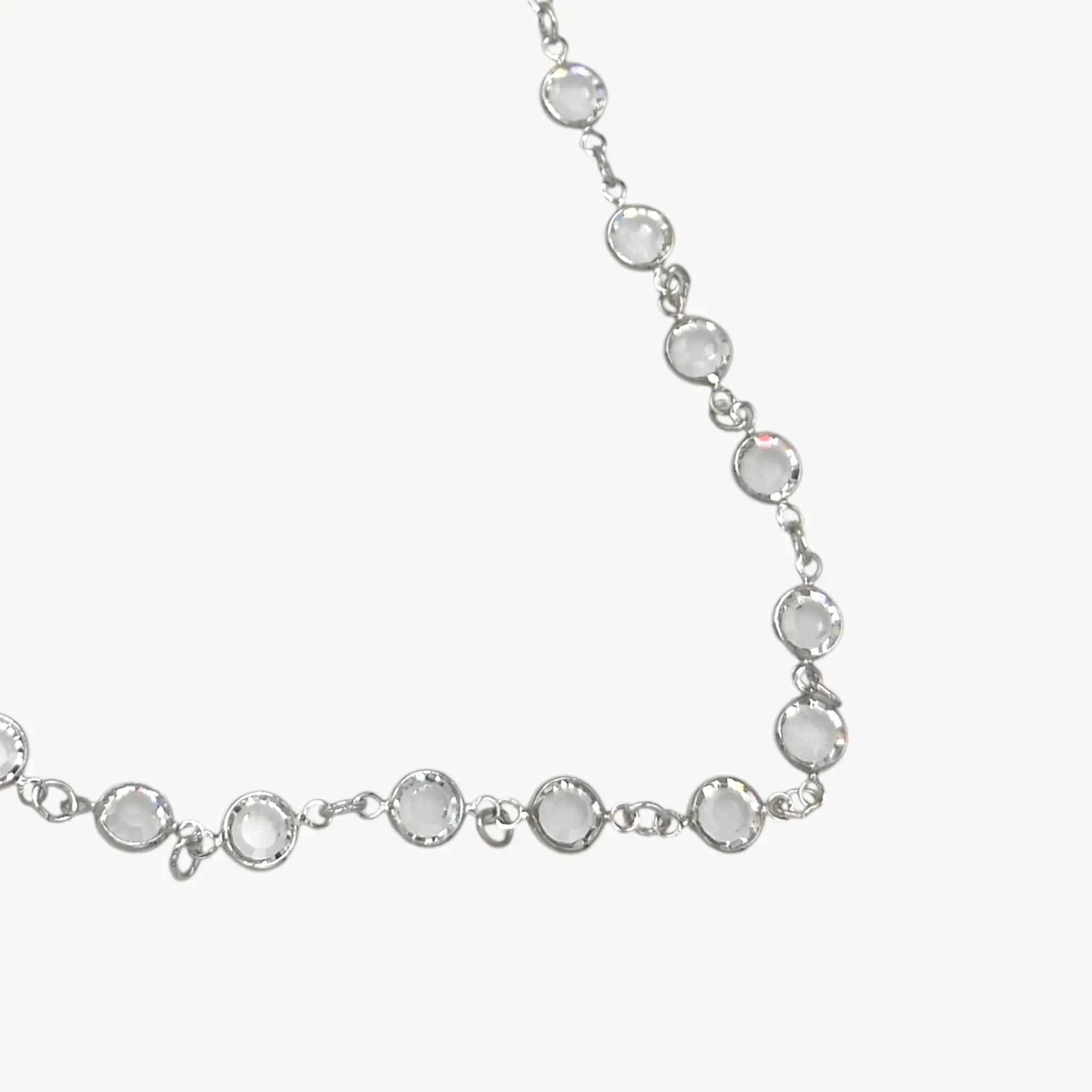 Close up of faceted crystal links of Swarovski faceted clear crystal bezel set long necklace.
