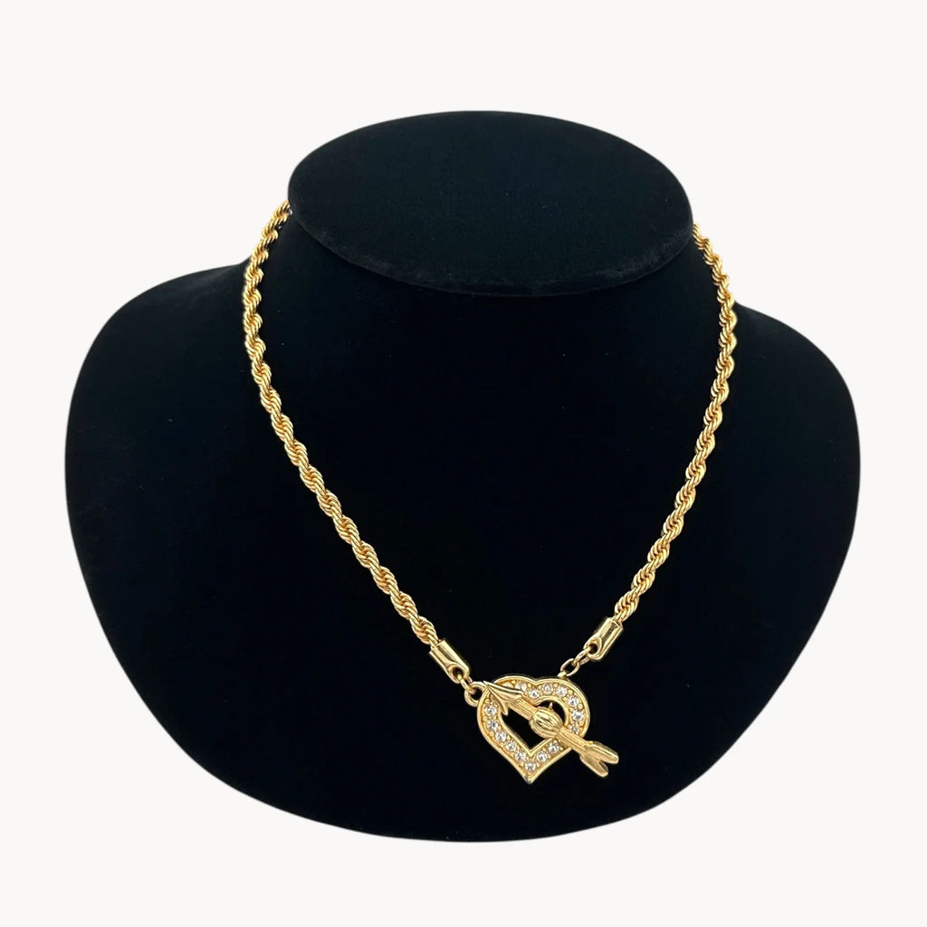 Close up view of Swarovski gold rope chain necklace with pave heart toggle clasp.