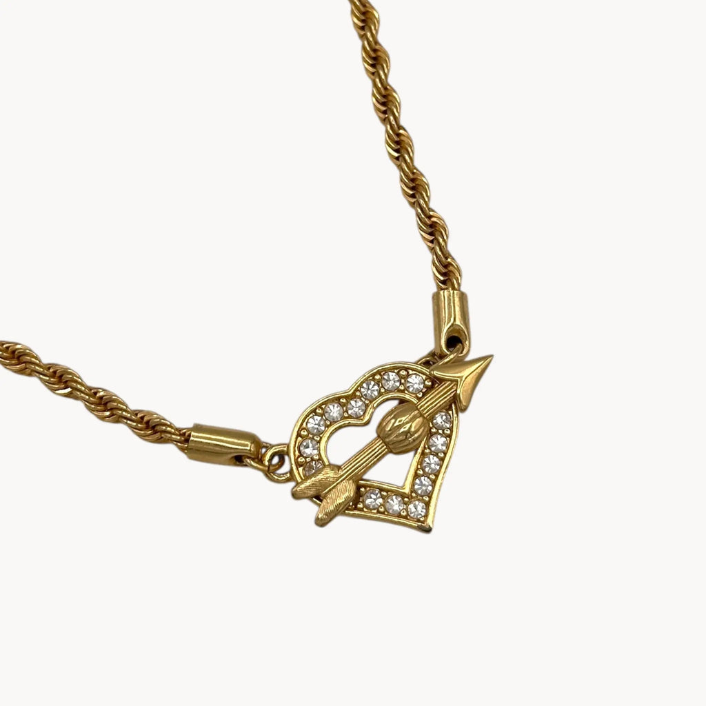 Close up view of toggle closure of Swarovski gold rope chain necklace with pave heart toggle clasp.