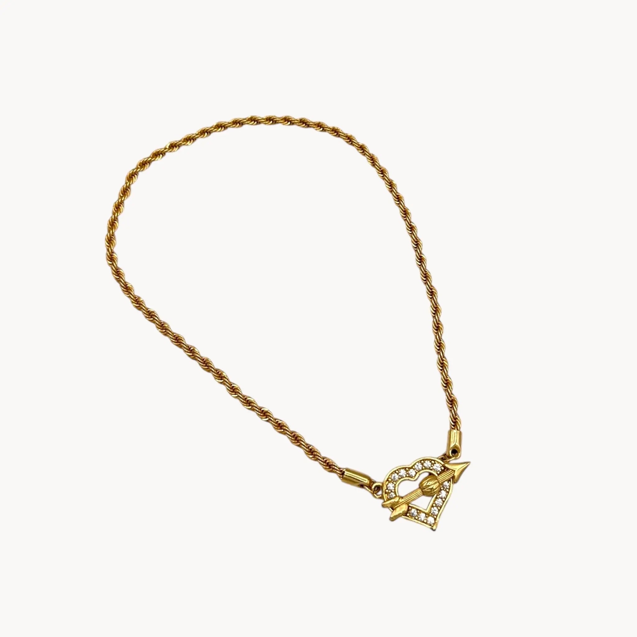 Against white background Swarovski gold rope chain necklace with pave heart toggle clasp