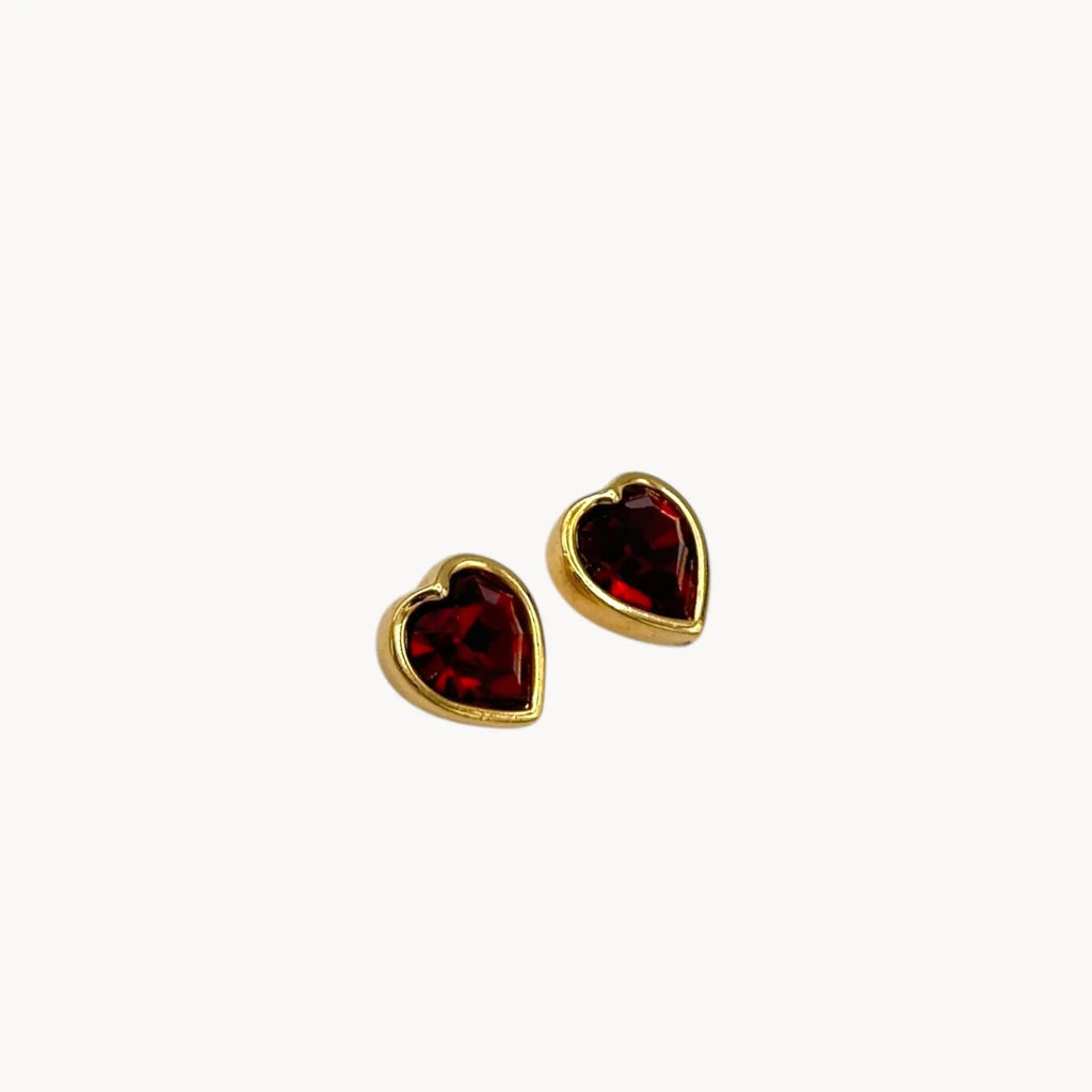 Side view of Swarovski SAL vintage red crystal heart pierced earrings with gold-tone setting.