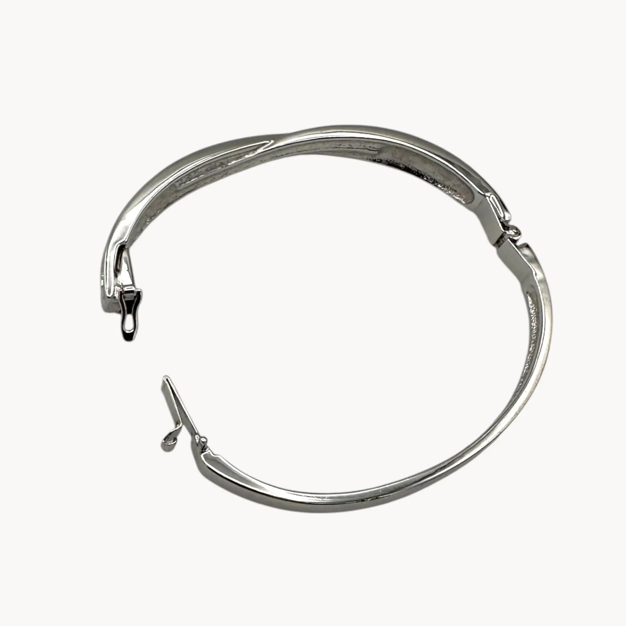 Open hinge view of Swarovski silver-tone crystal bangle bracelet with elegant sparkling design.