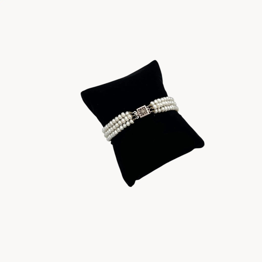 Three row pearl bracelet with silver-tone Art Deco style clasp.