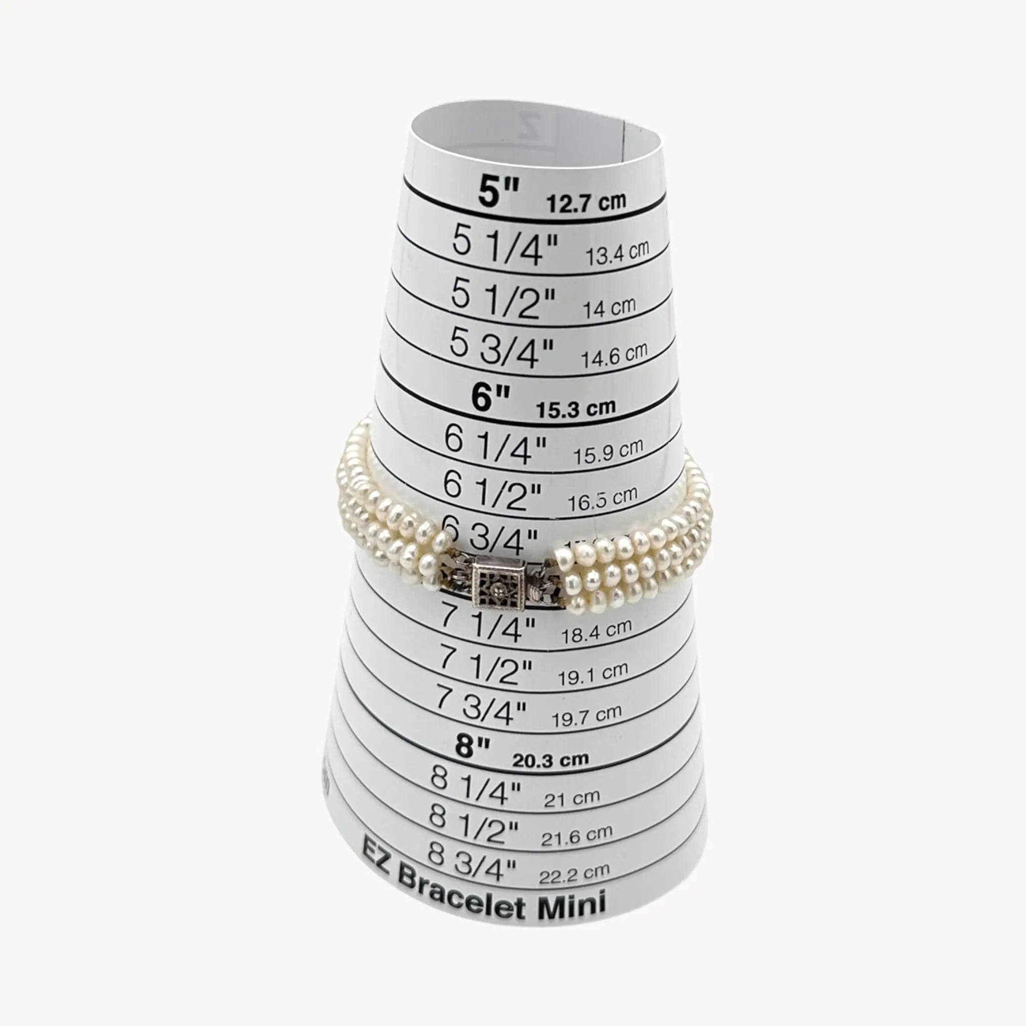 on sizer view of Three row pearl bracelet with silver-tone Art Deco style clasp.