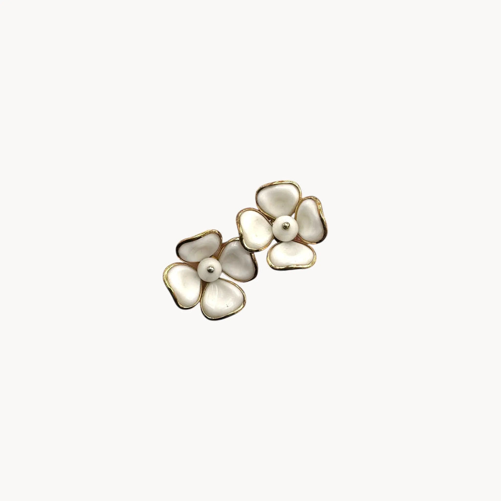 Last view of Vintage Trifari gold-tone dogwood flower clip-on earrings with white milk glass petals on white background.