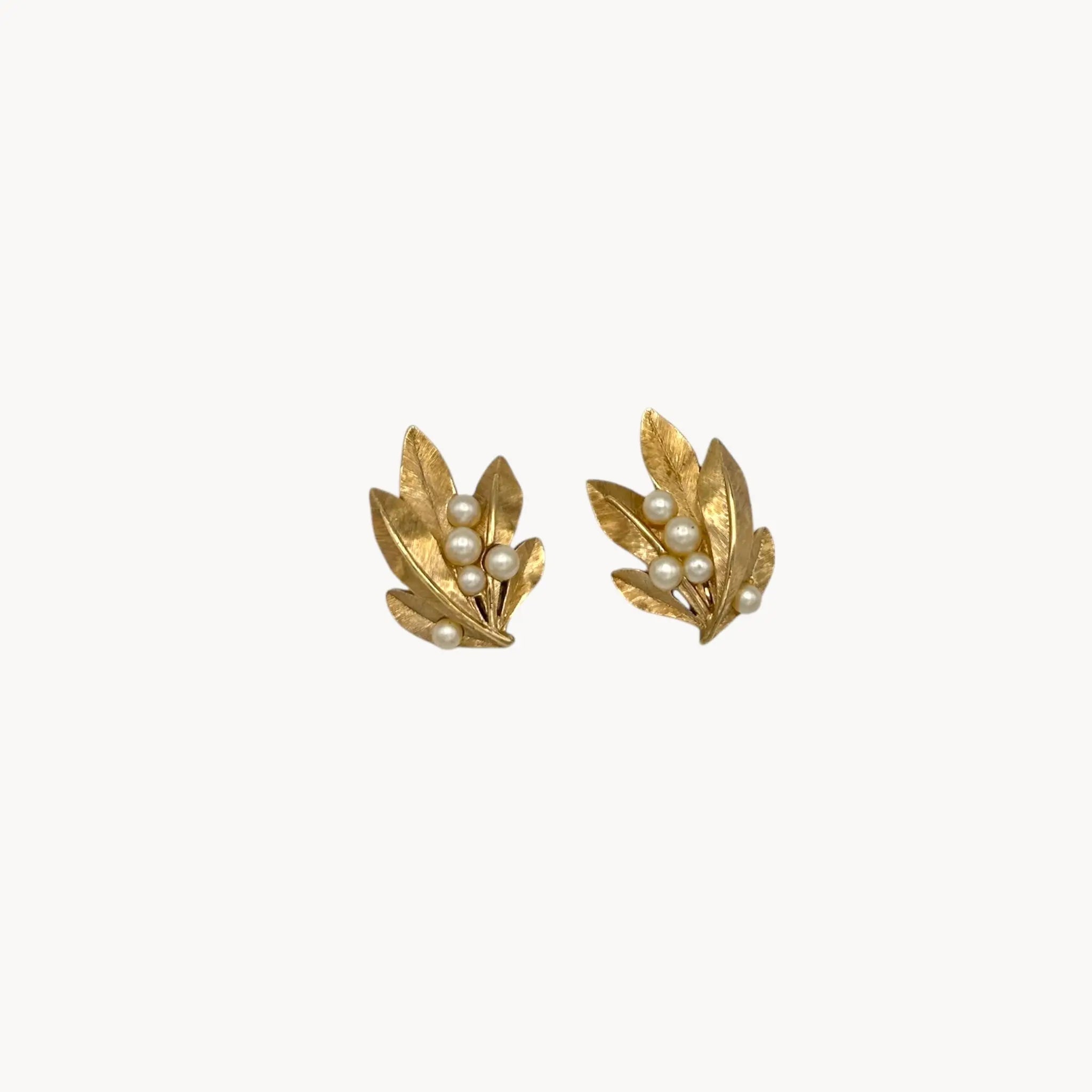 Vintage Trifari gold leaf clip-on earrings with faux pearls, 1960s jewelry on white background.