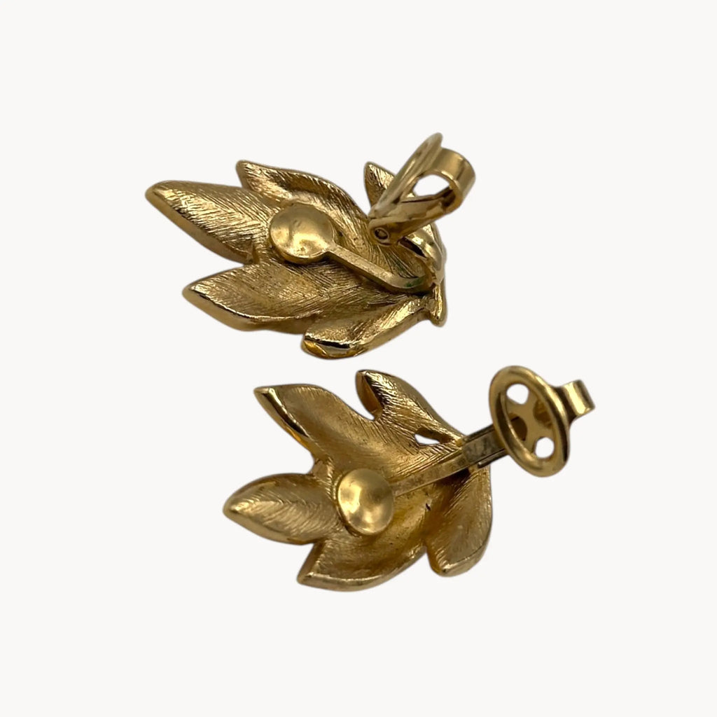 Back view with clips up of Vintage Trifari gold leaf clip-on earrings with faux pearls, 1960s jewelry on white background.