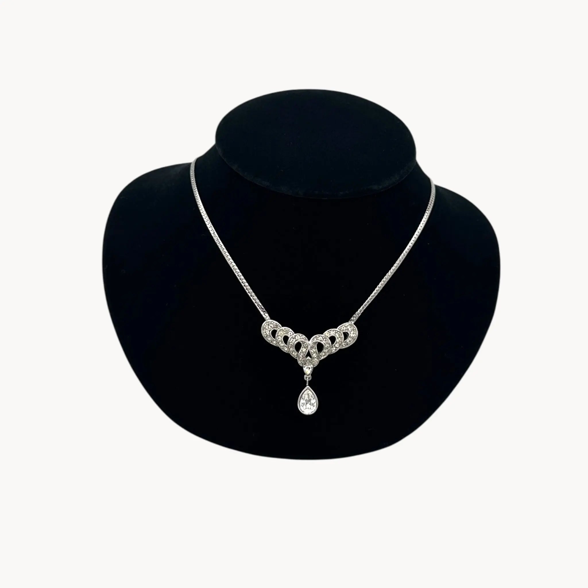 Close up view of Trifari 1980s rhinestone necklace with teardrop centerpiece, vintage bridal jewelry