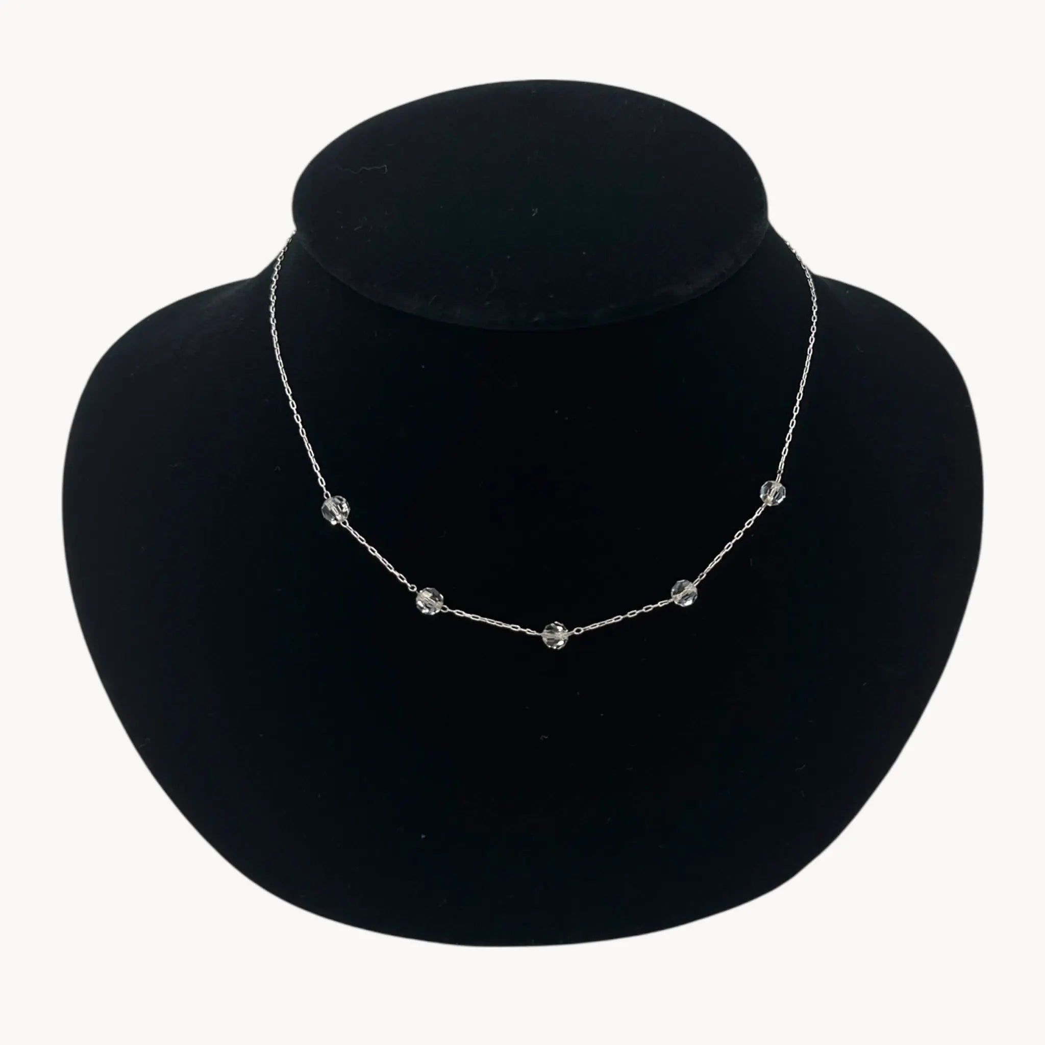 Close up view of Van Dell sterling silver crystal station necklace, mid-century vintage jewelry.