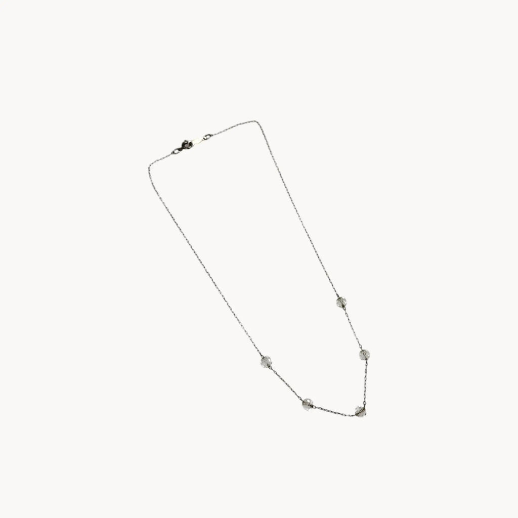 Against white background Van Dell sterling silver crystal station necklace, mid-century vintage jewelry.