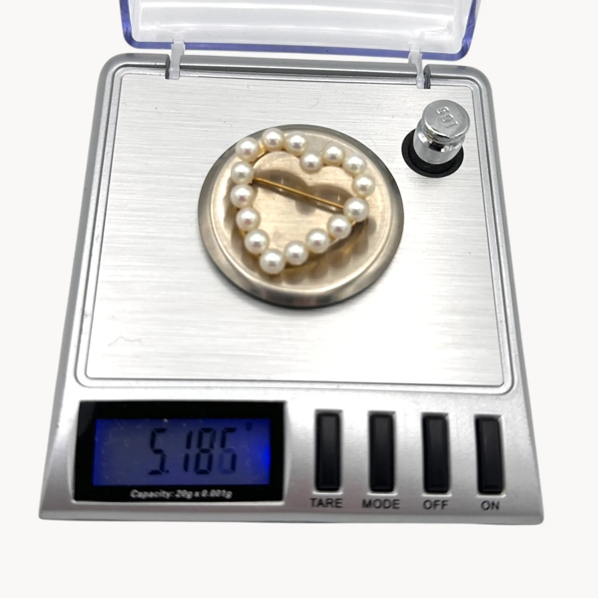 On scale view of Vintage 14K gold heart brooch with cultured pearls in a romantic design.