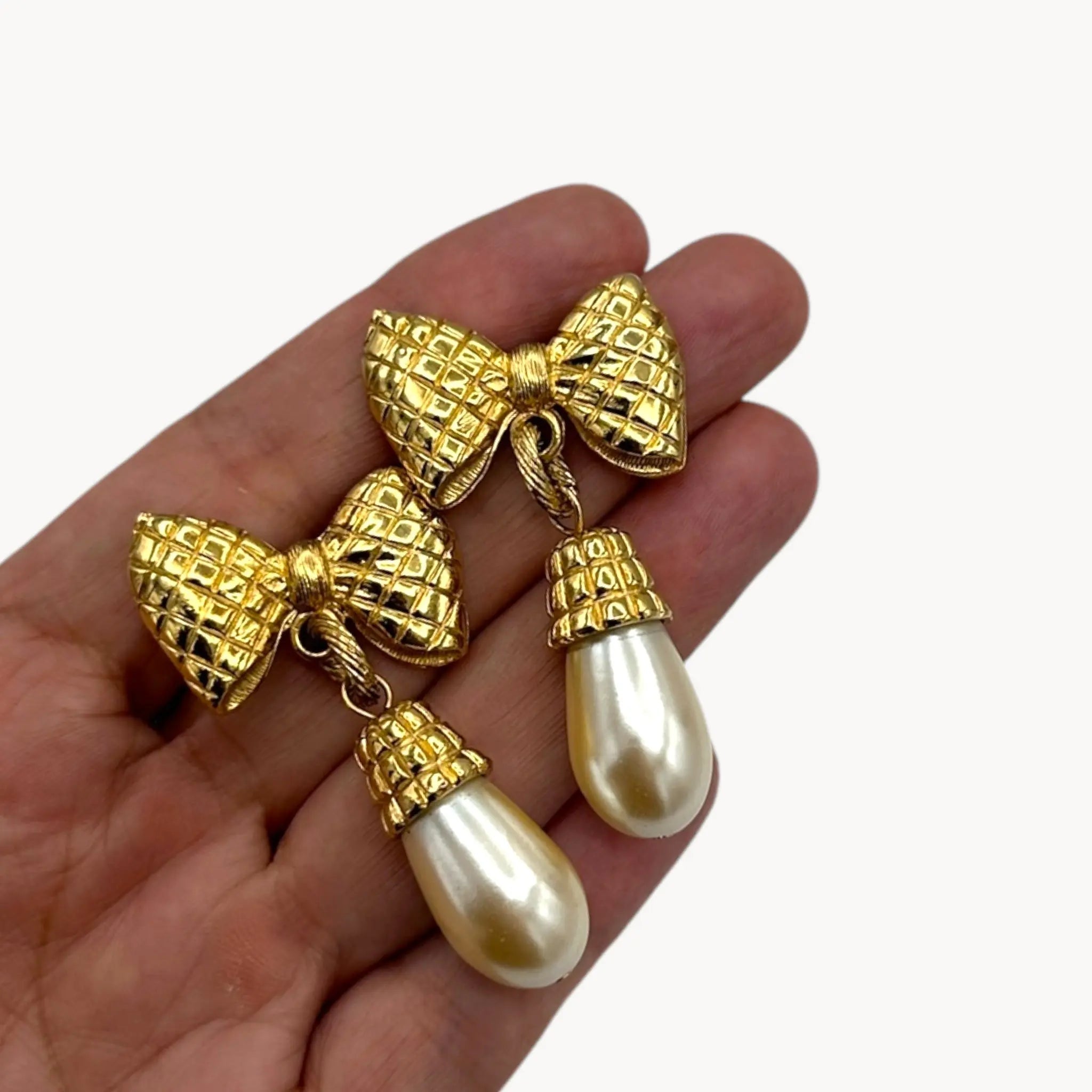 Scale size view Vintage 1980s gold bow earrings with faux pearl drops, unsigned pierced bridal jewelry.