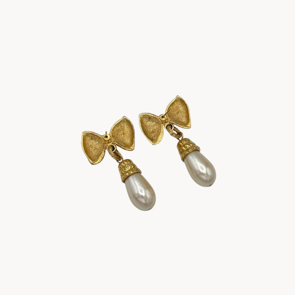 Back view of Vintage 1980s gold bow earrings with faux pearl drops, unsigned pierced bridal jewelry.