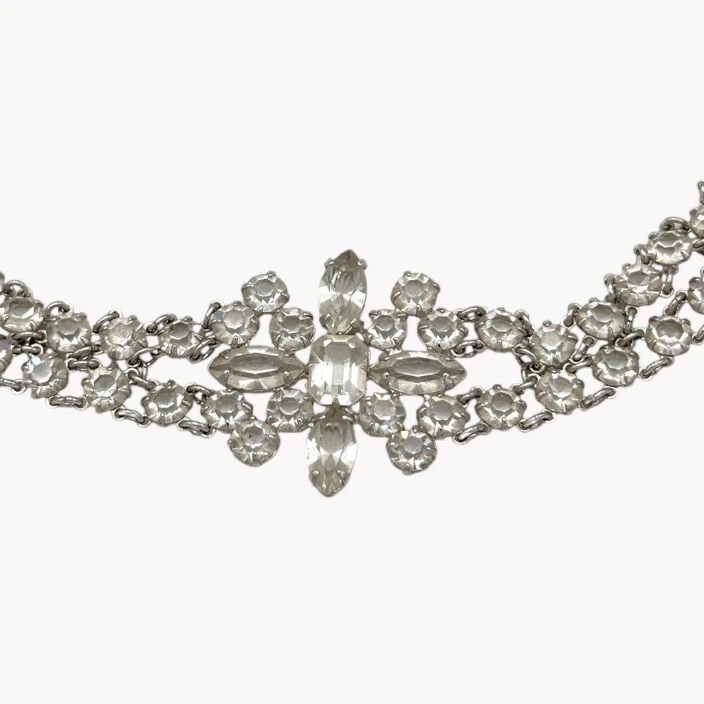 Silver necklace with clear crystals on a white background