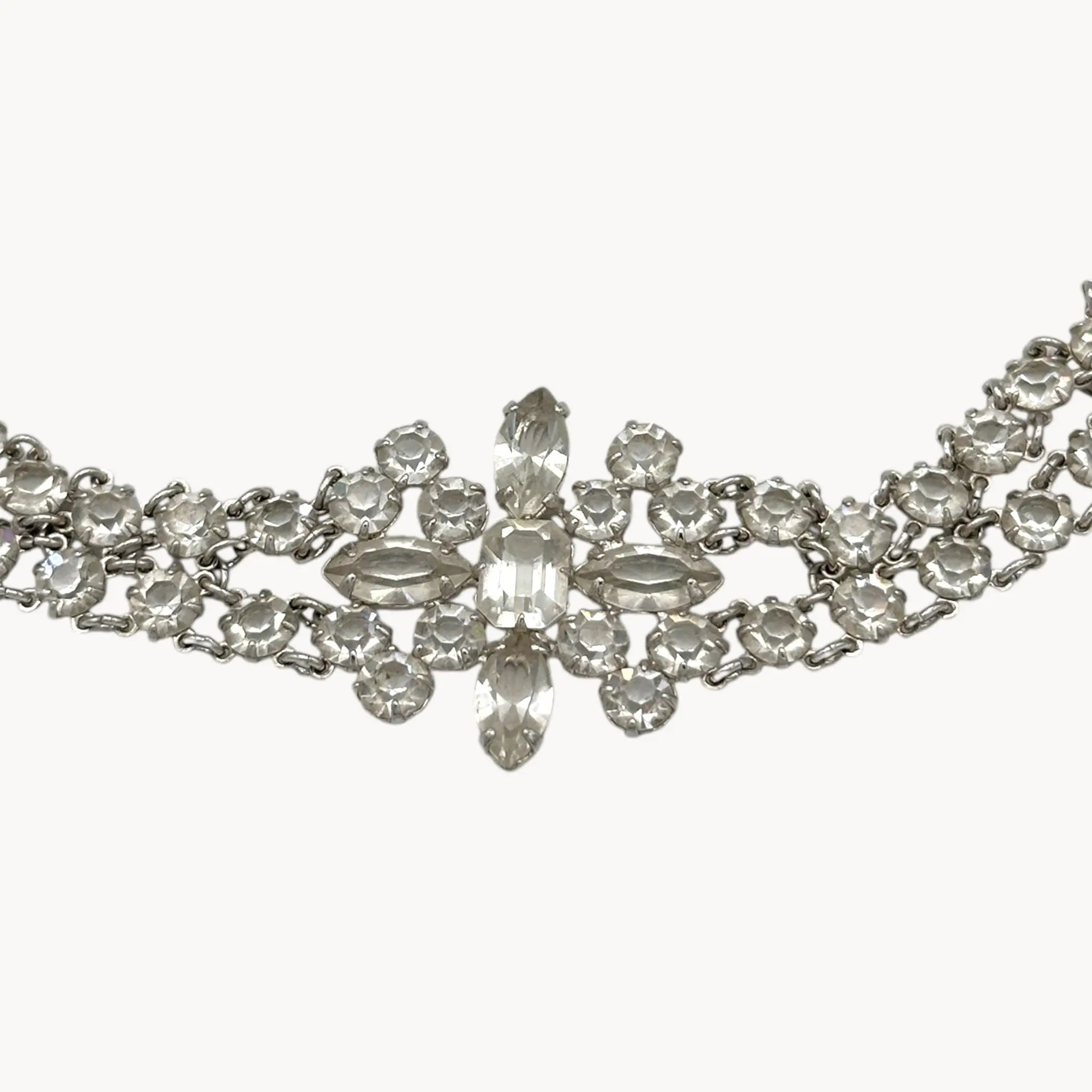 Silver necklace with clear crystals on a white background