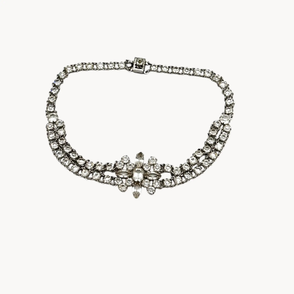 Art Deco crystal necklace on white background.