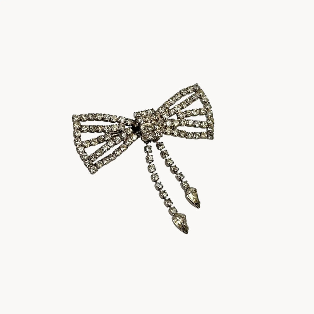 Side view of Vintage Art Deco style rhinestone bow brooch with dangle drops.