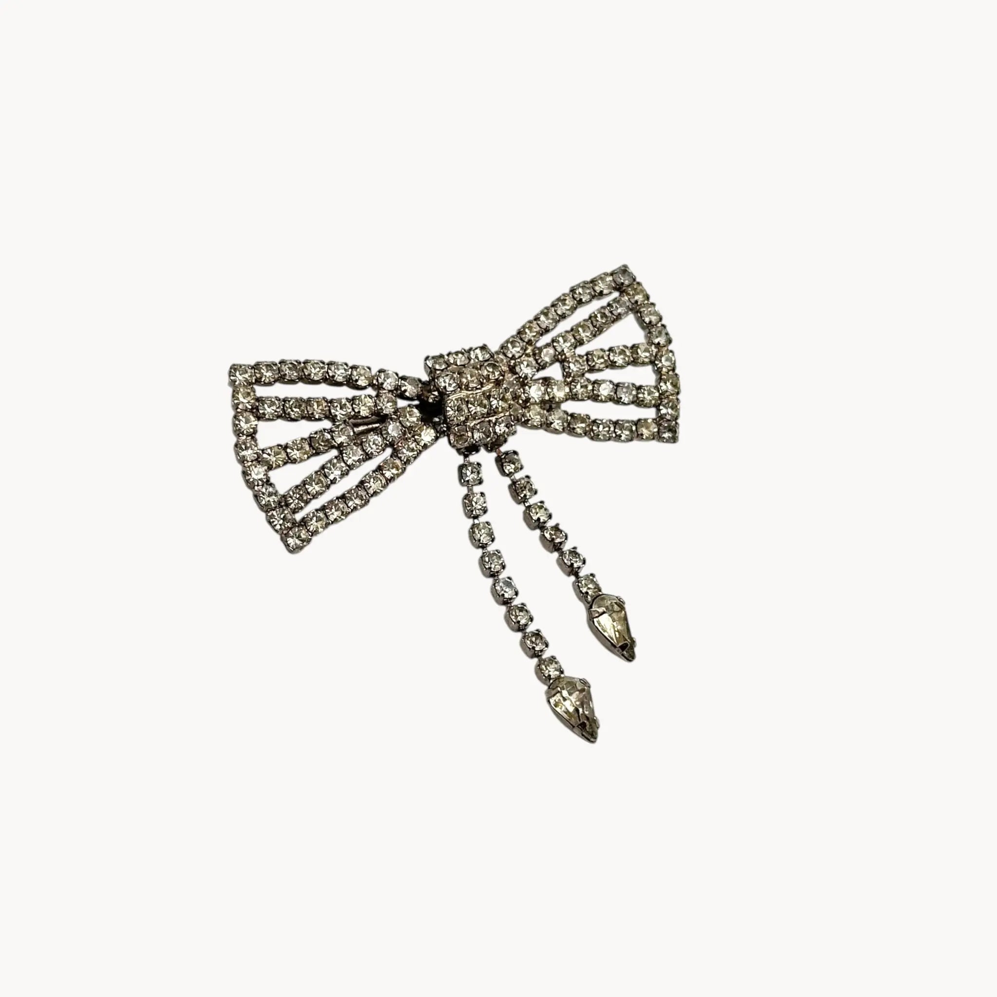 Side view of Vintage Art Deco style rhinestone bow brooch with dangle drops.