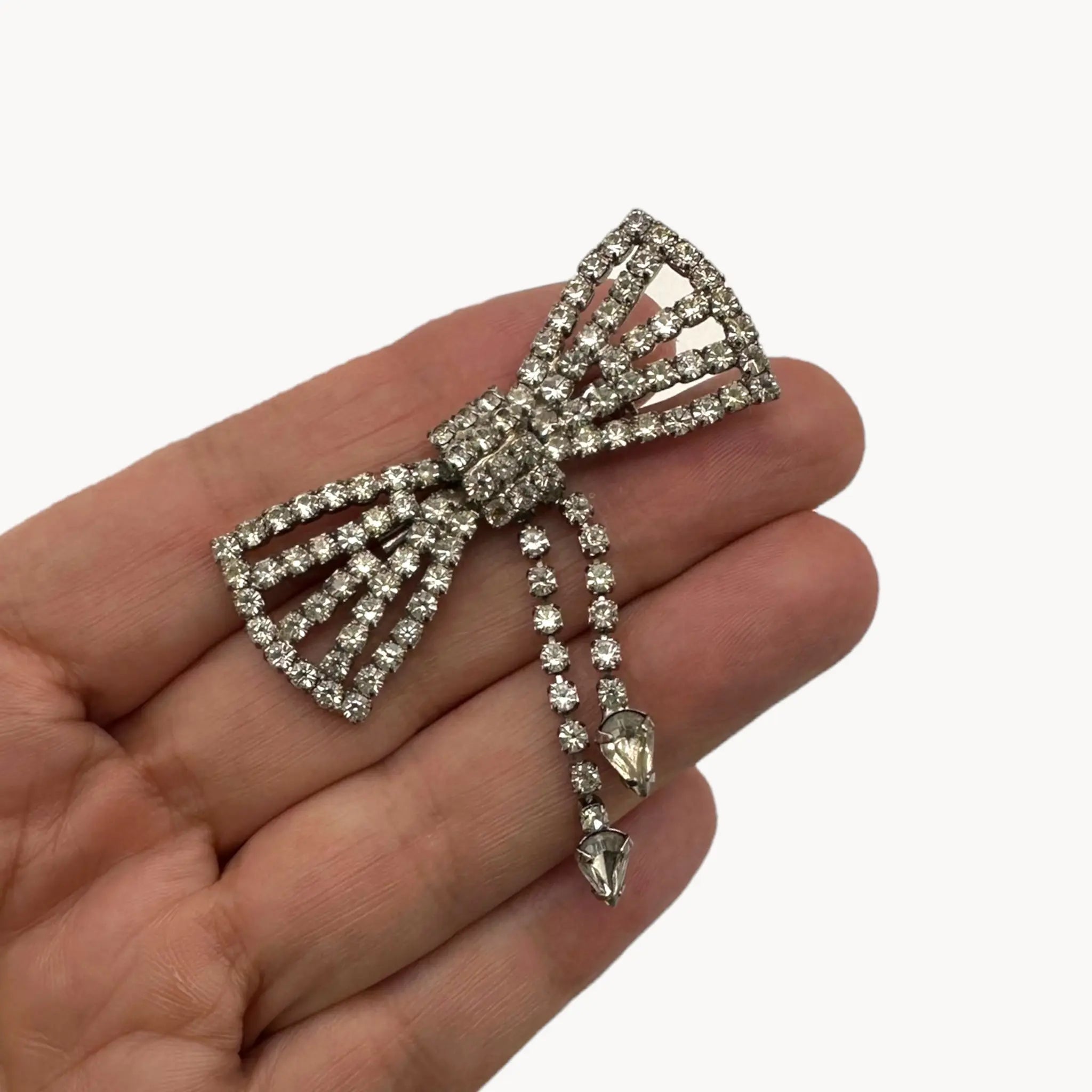 Size view of Vintage Art Deco style rhinestone bow brooch with dangle drops.