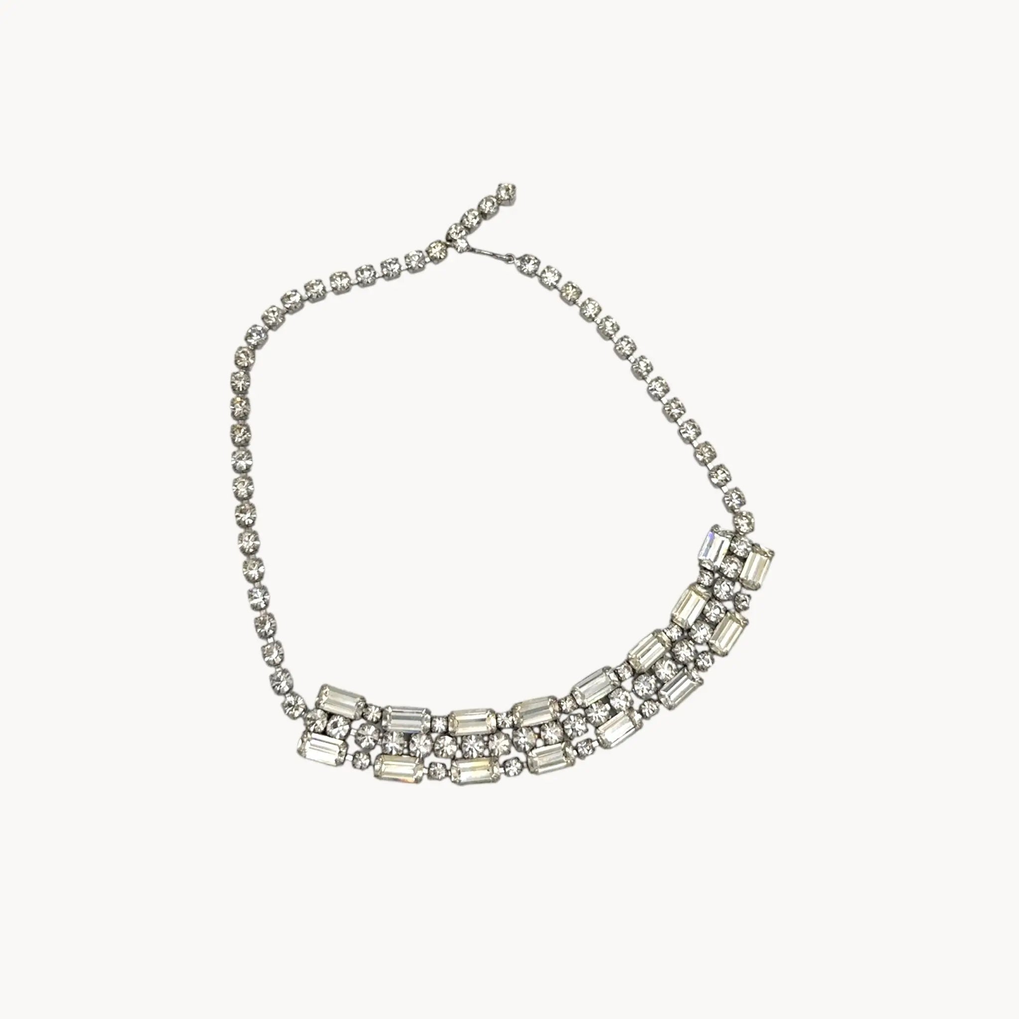 Against white background Vintage Art Deco style rhinestone choker necklace with baguette and round stones, unmarked 1950s bridal jewelry