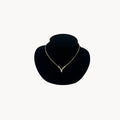 Vintage Christian Dior necklace with gold-tone chain and V-shaped crystal pendant, 1990s bridal jewelry.