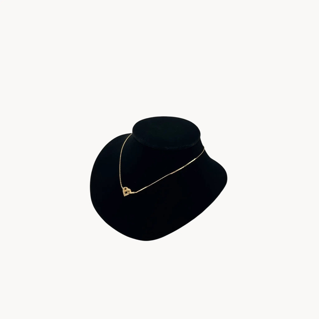 Side view of Vintage Christian Dior gold heart pendant necklace with rhinestone detail.