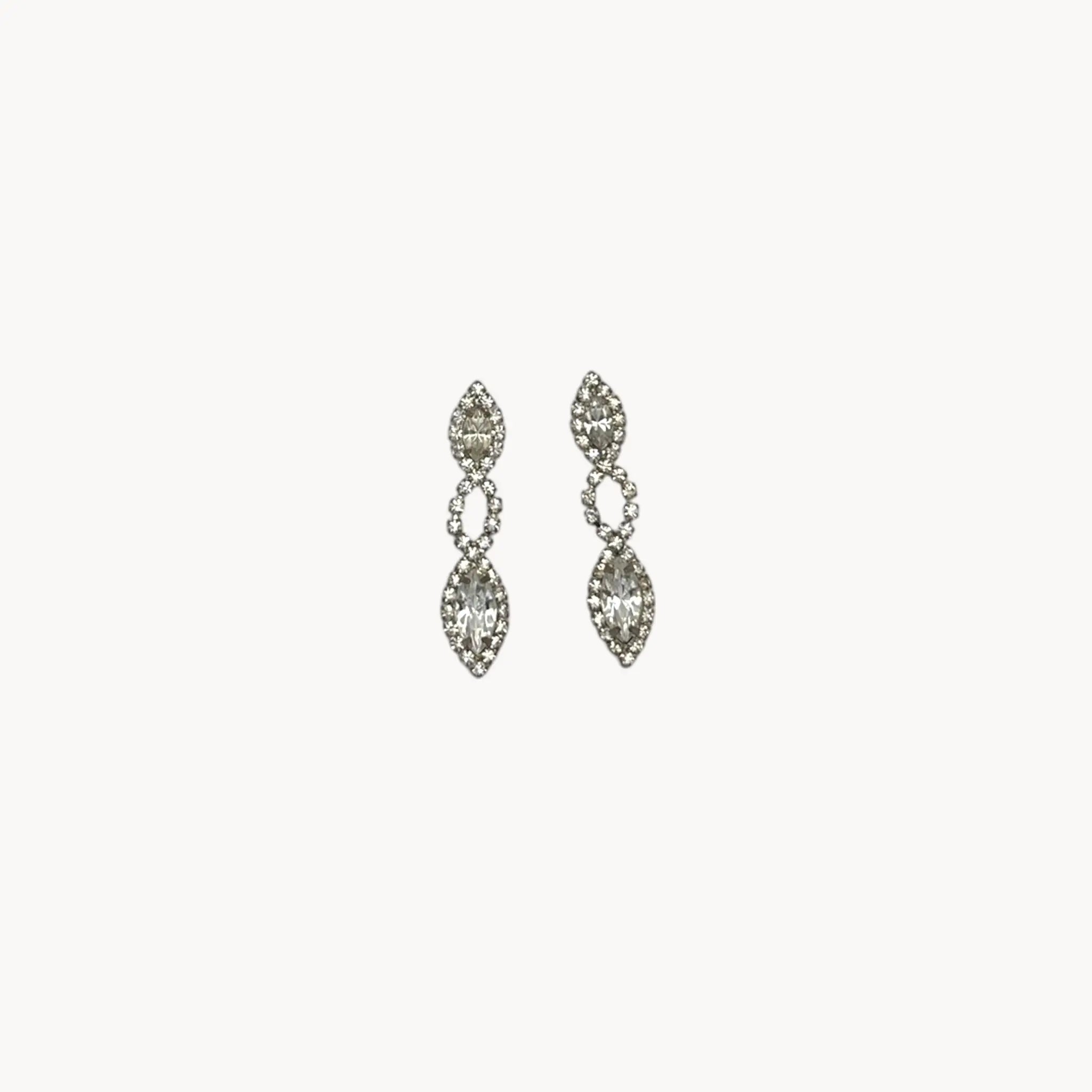 Close up view of Vintage clear rhinestone dangle pierced earrings with marquise stones, bridal jewelry.