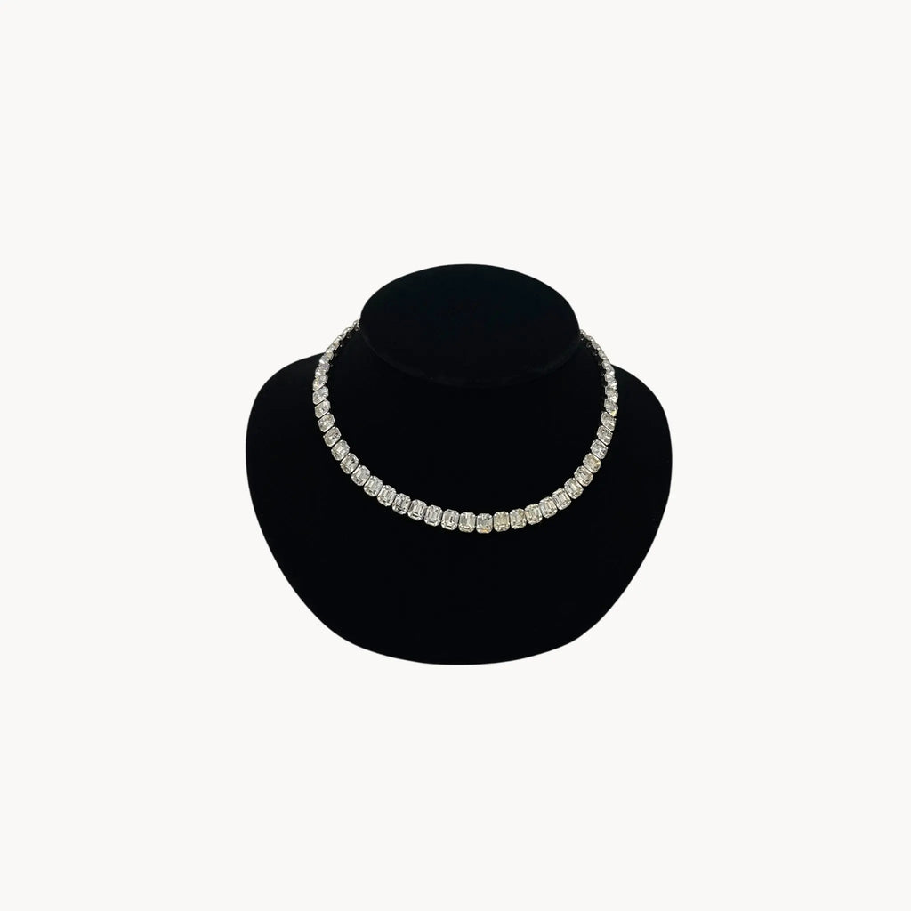 Eisenberg Rhinestone vintage necklace black velvet stand against a white background.