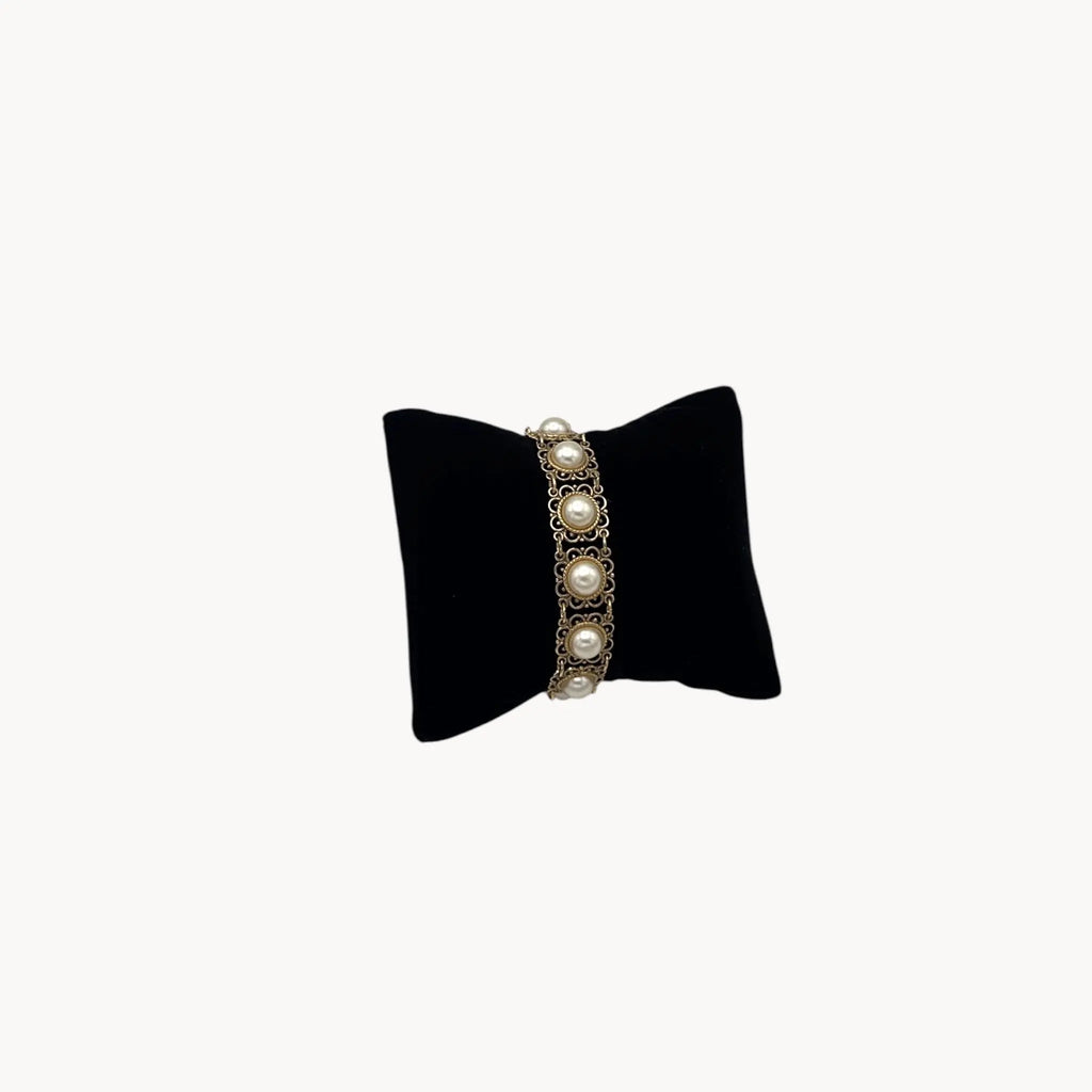 Front view of Vintage Faux Pearl & Gold Filigree Bracelet on black pillow.