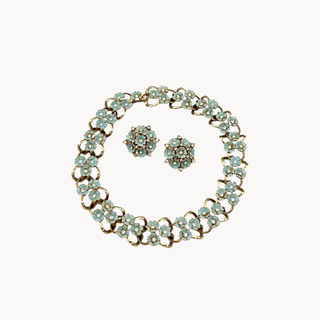 Against white background Vintage mid-century forget-me-not floral necklace and earring set with blue enamel flowers and rhinestones, 1950s bridal jewelry.