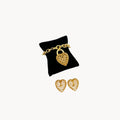 Vintage gold caged pearl heart bracelet and matching clip-on earrings set, 1980s–1990s jewelry on white background.