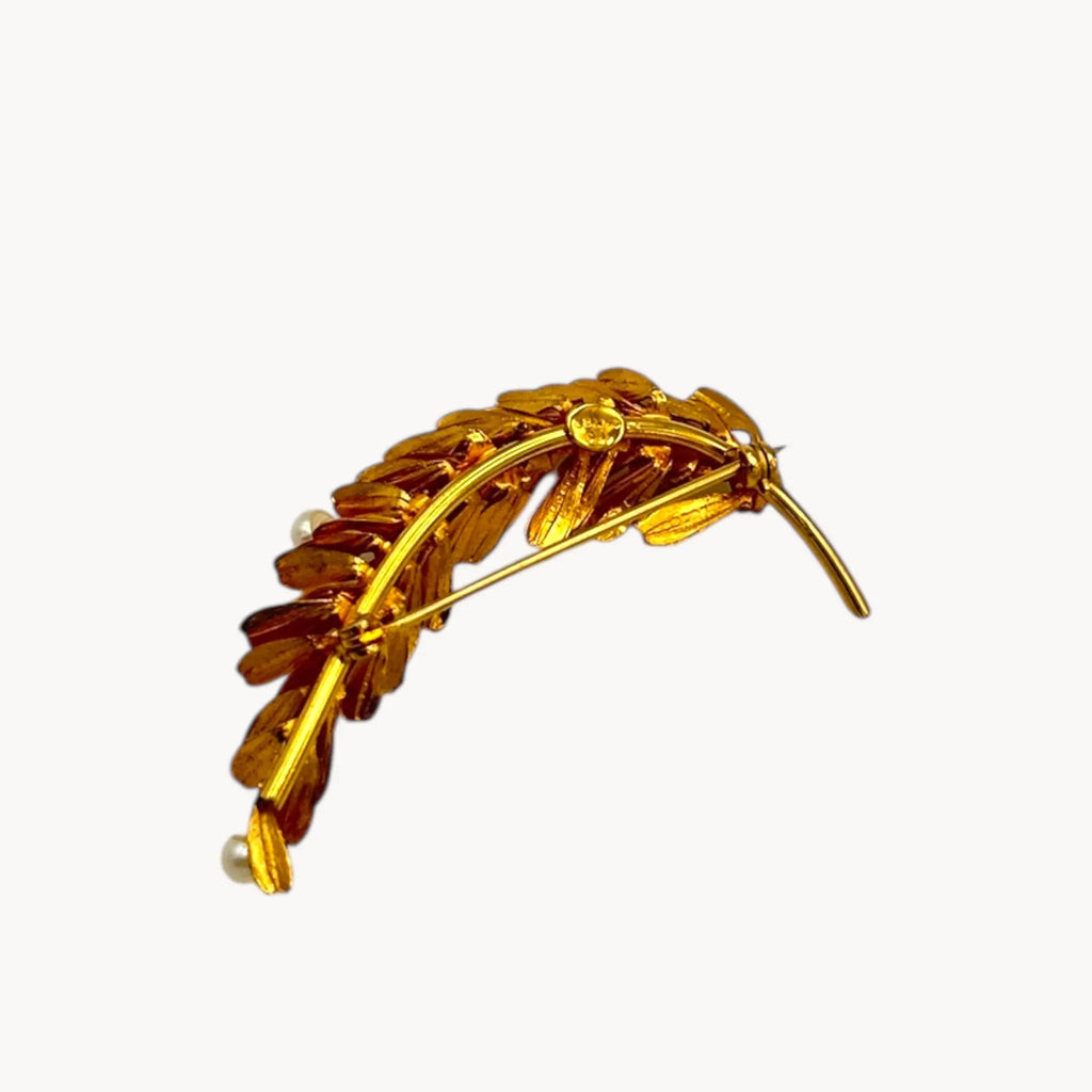 Back view of Vintage gold-filled floral brooch with detailed leaf design and real pearl accents, mid-century shown on white background.