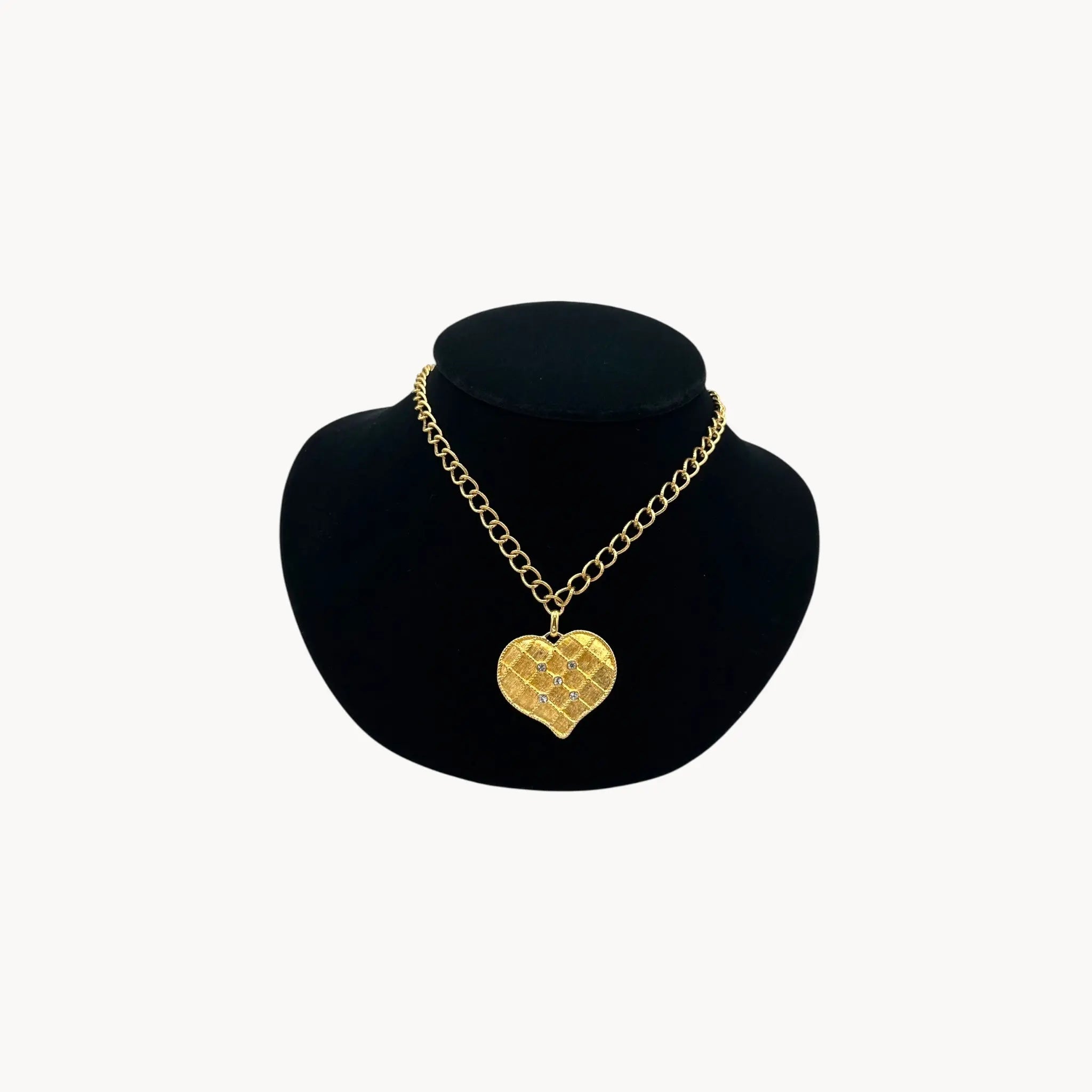 Vintage gold heart pendant necklace with rhinestone accents on a chunky chain.