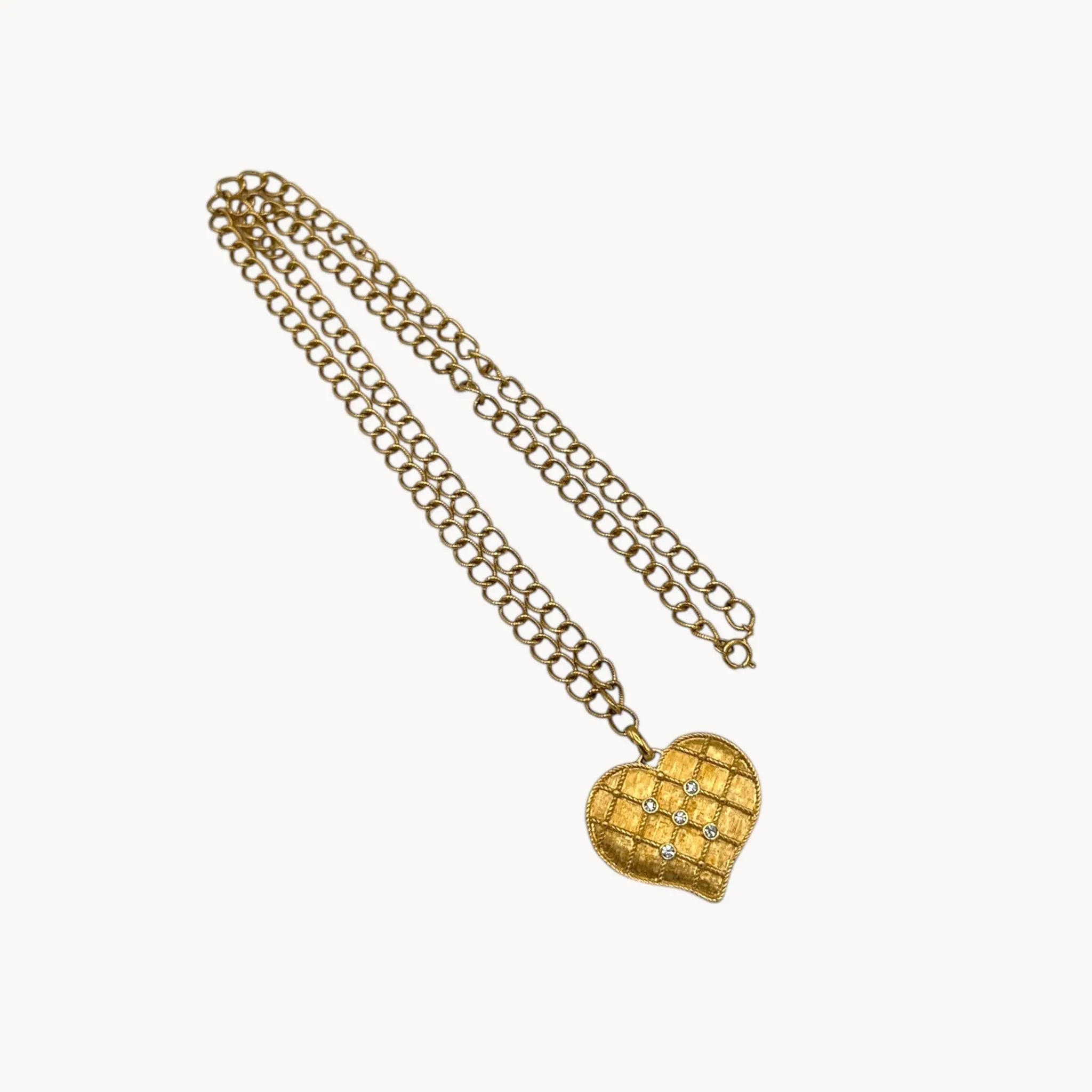 Against white background of Vintage gold heart pendant necklace with rhinestone accents on a chunky chain.