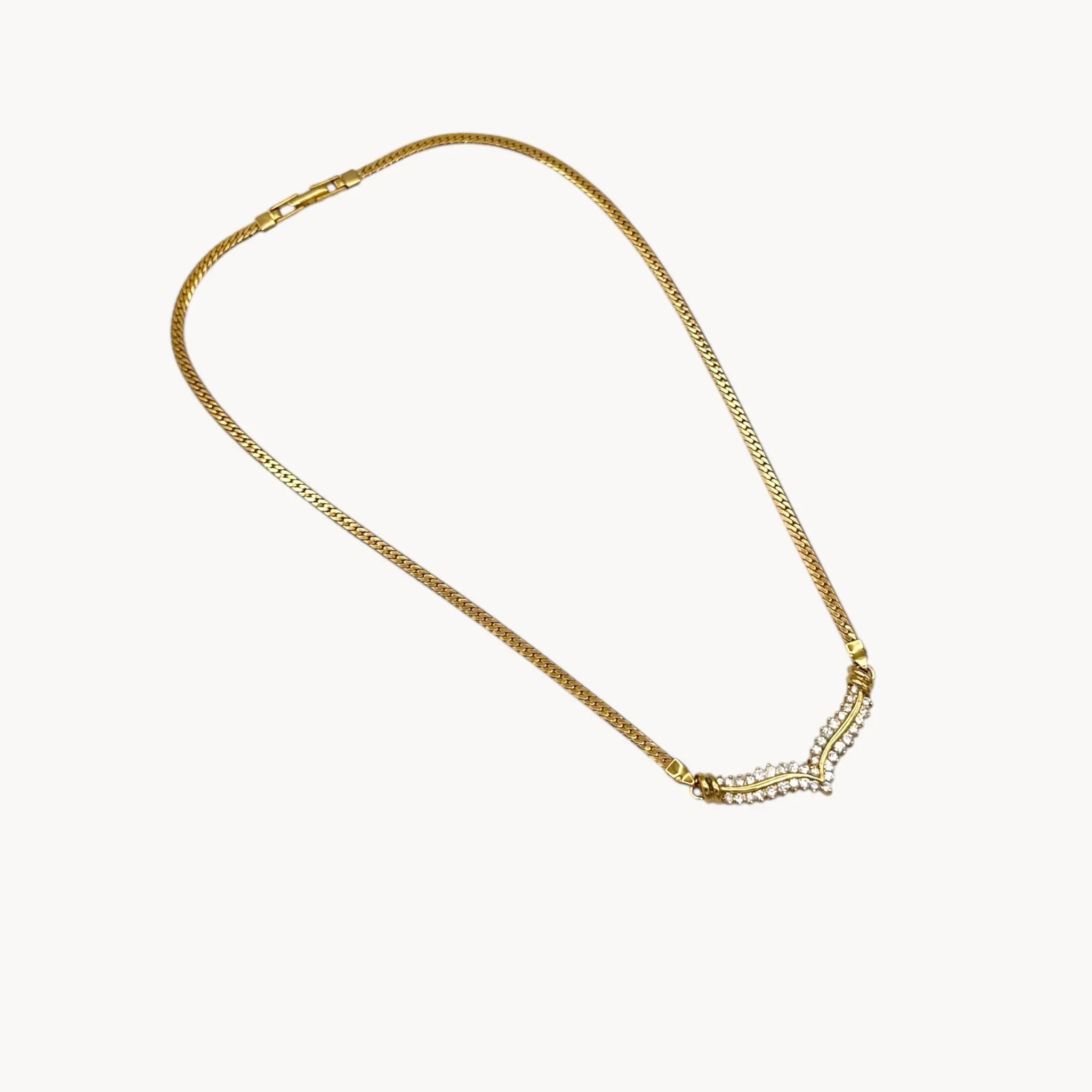 Vintage gold rhinestone chevron necklace from the 1980s–1990s on white background.