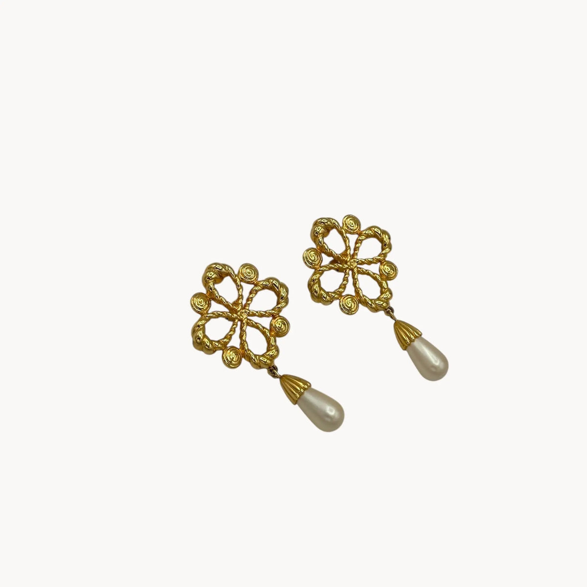 Side view Vintage Joan Rivers clip-on earrings with gold filigree design and faux pearl drops, 1990s bridal jewelry.