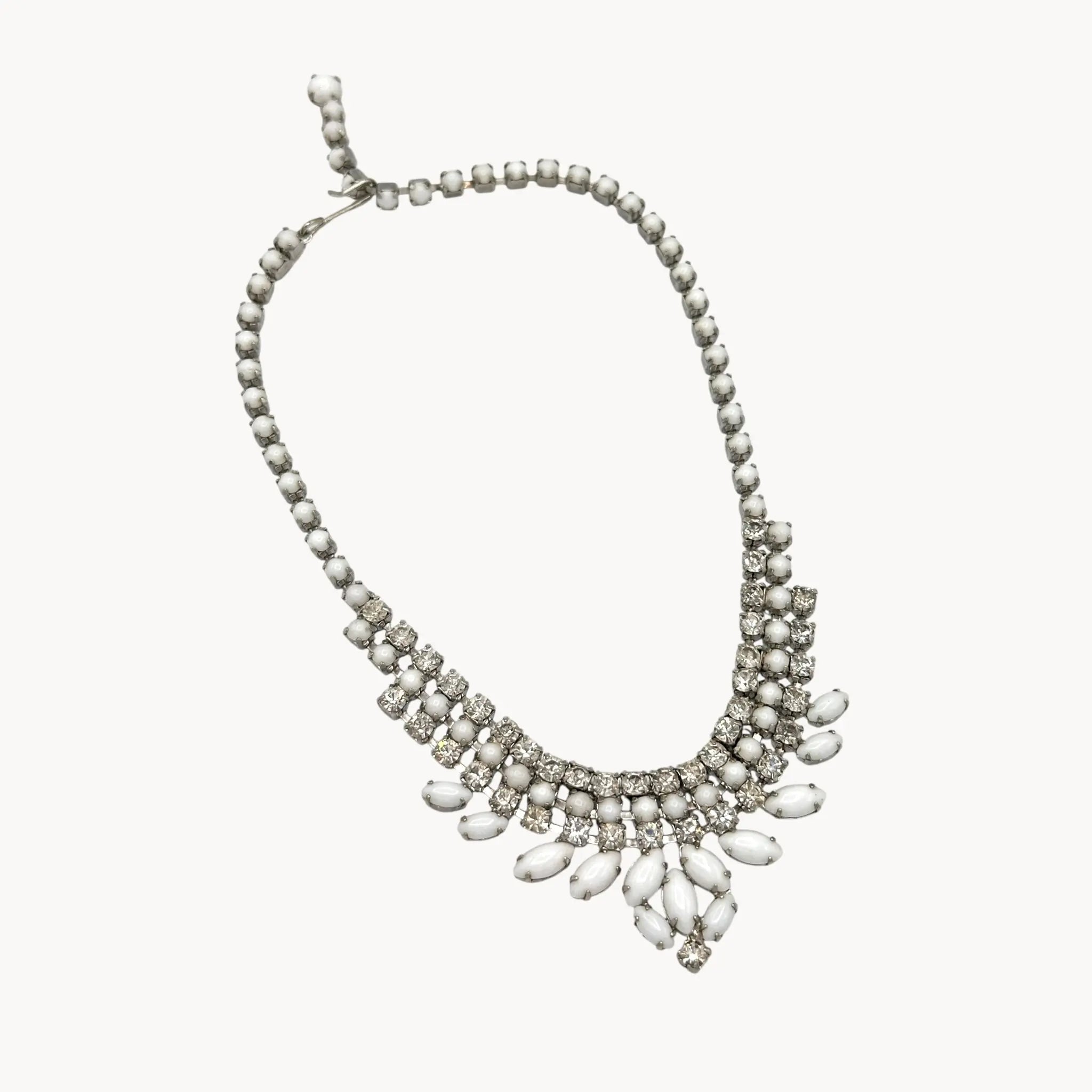 on white background Vintage Joseph Warner rhinestone necklace with tiered clear crystals and white marquise accents, 1950s–1960s bridal statement jewelry.