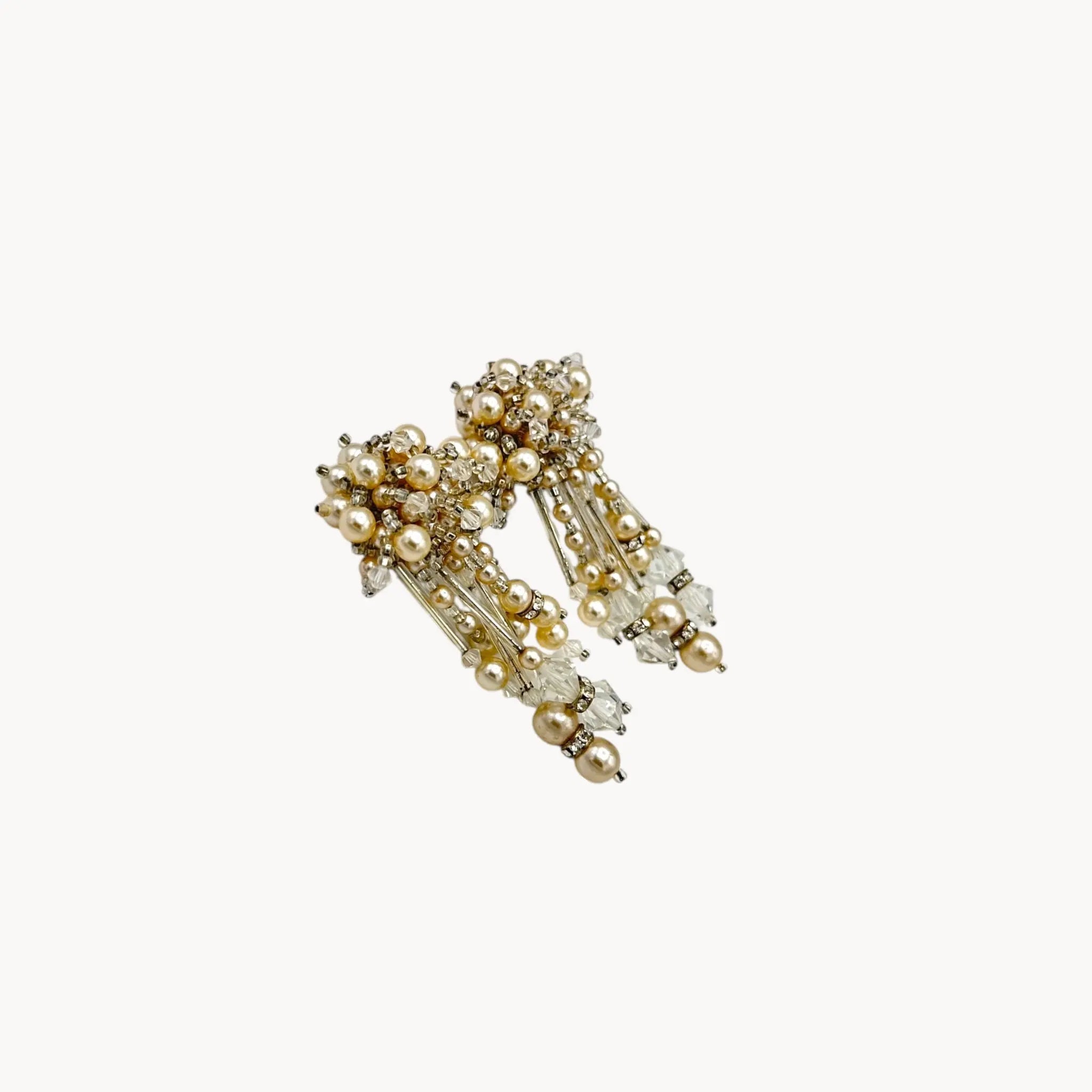 Side view of Vintage Lois Ann Pearl & Crystal Beaded Cascade Clip-On Earrings on white background.