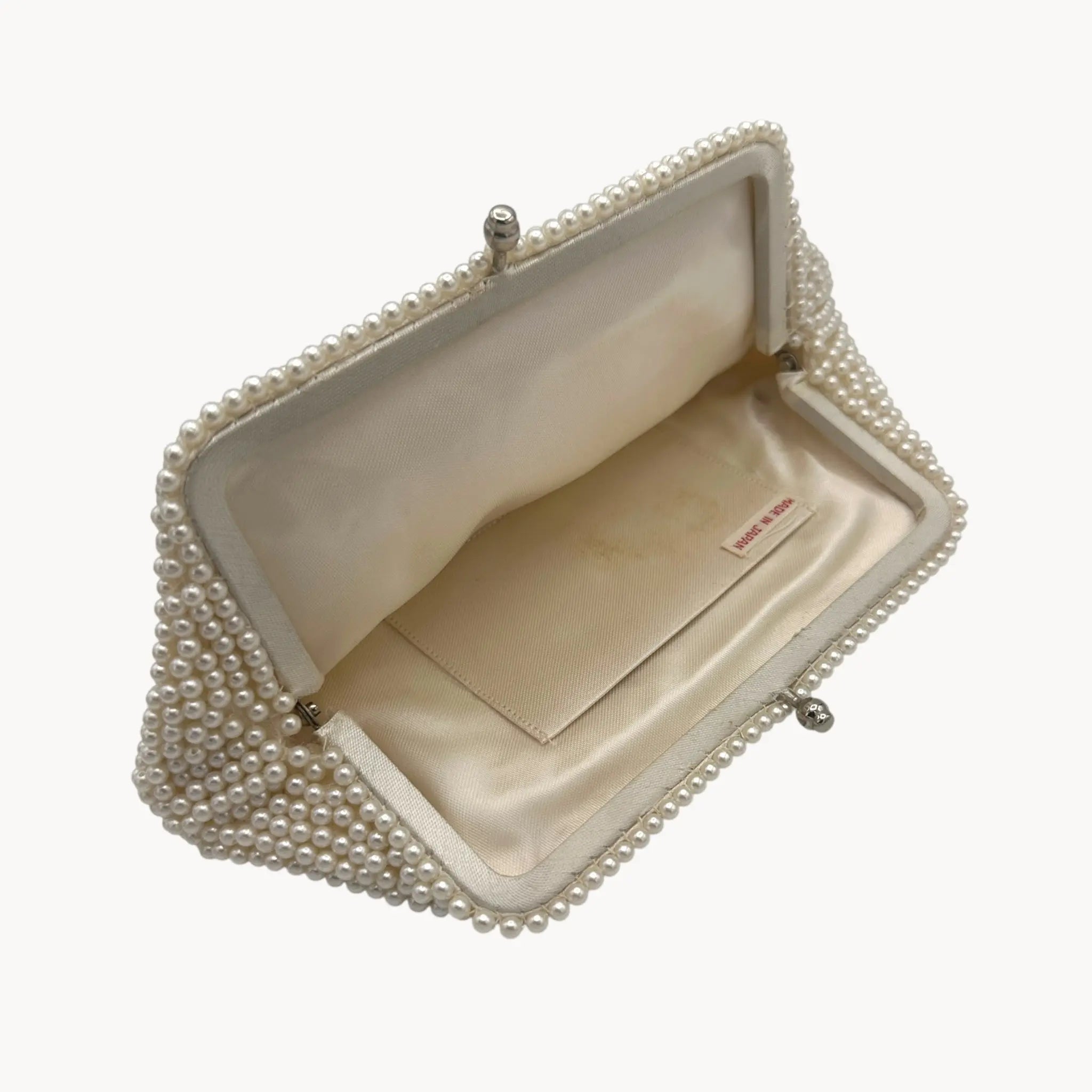 Closer open view of Vintage Made in Japan small pearl beaded clutch handbag, 1950 bridal purse on white background.