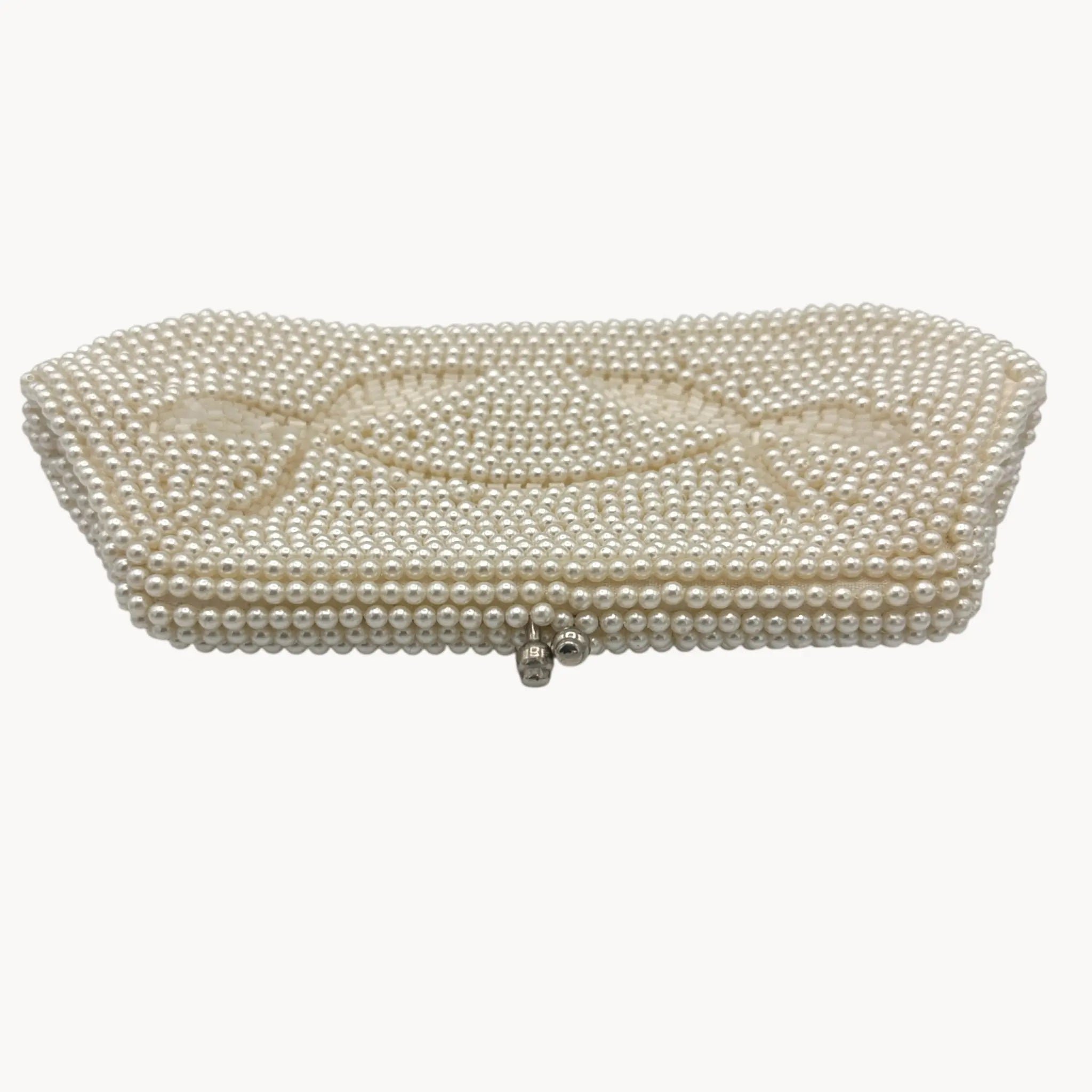 Top view of Vintage Made in Japan small pearl beaded clutch handbag, 1950 bridal purse on white background.