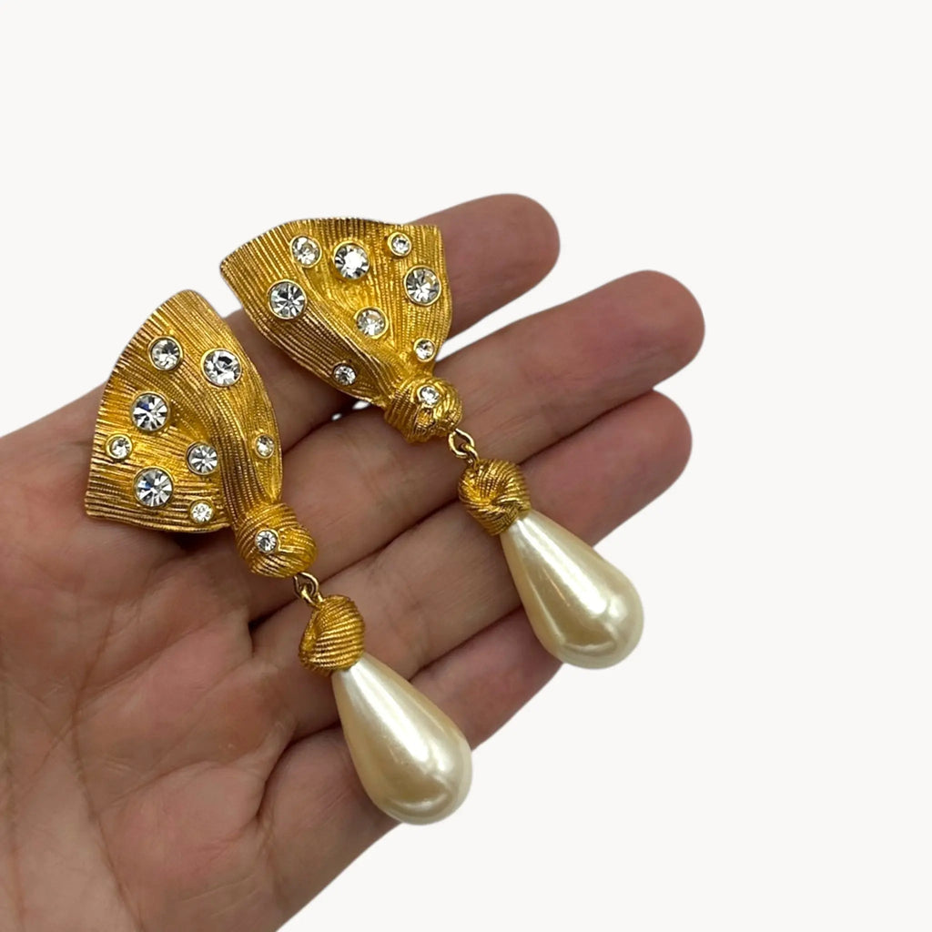 scale size view Vintage Marvella clip-on earrings with gold fan-shaped tops, crystal accents, and faux pearl drops, 1980s bridal jewelry.